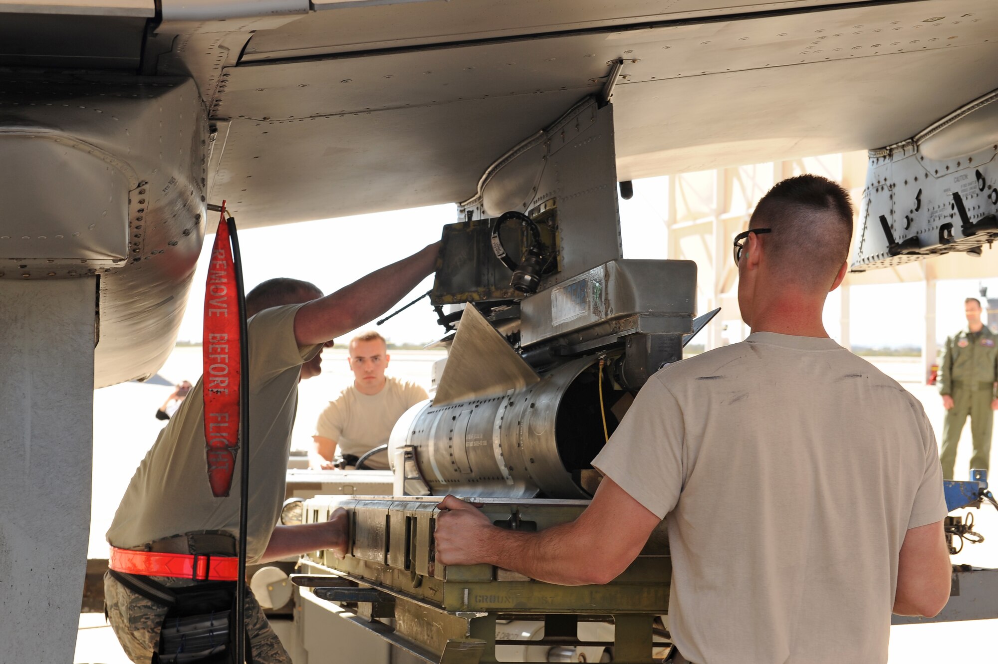U.S. Air Force weapons load crew Airmen assigned to the 354th Aircraft Maintenance Unit load an AGM-65 Maverick missile onto an A-10C Thunderbolt II during a load crew of the year competition at Davis-Monthan Air Force Base, Ariz., Feb. 5, 2016. The objective of the contest is to determine which team can load an A-10 with munitions the fastest with the least deficiencies. (U.S. Air Force photo by Senior Airman Cheyenne A. Powers/Released)
