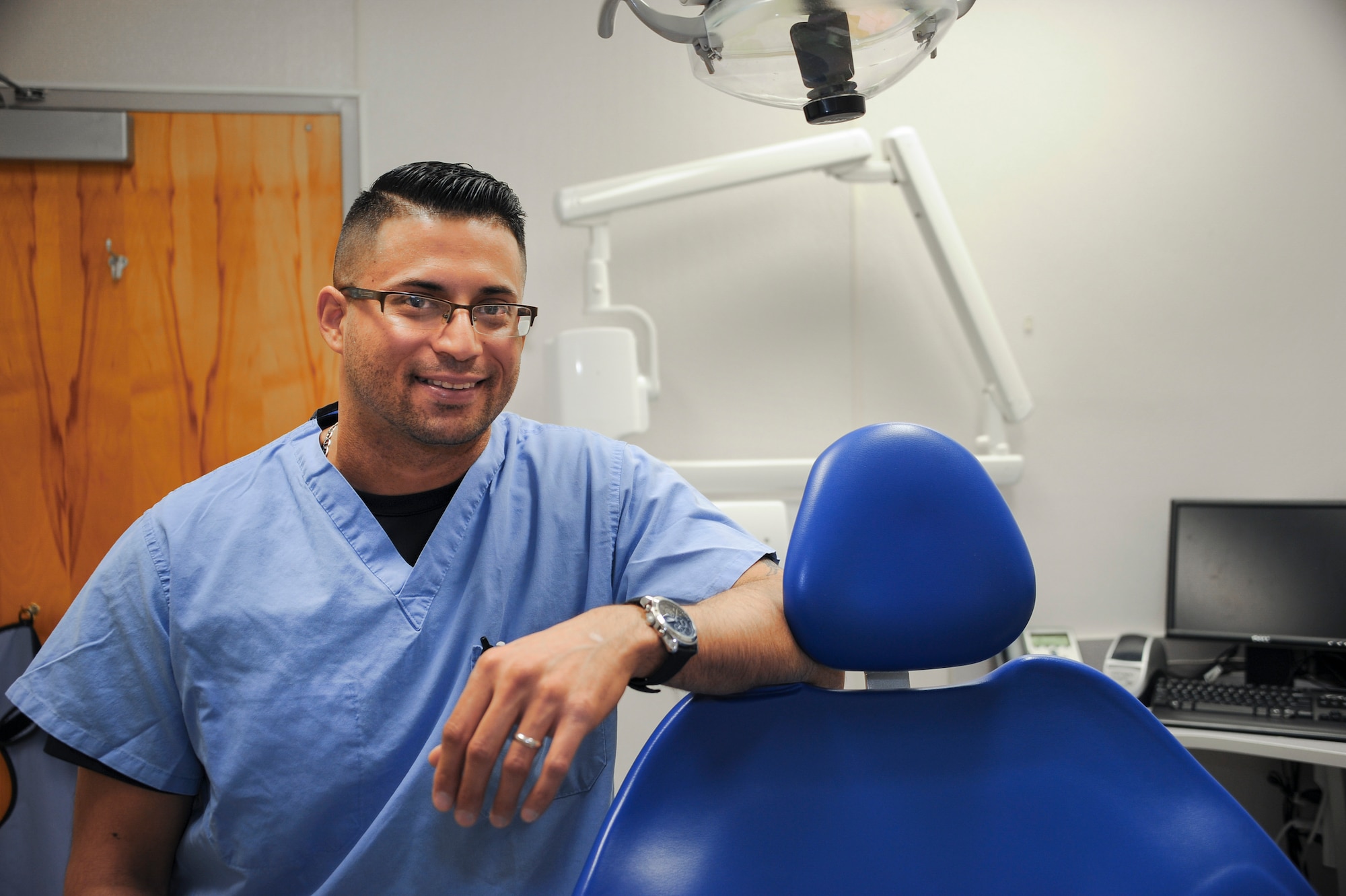 Ivan Grijalva, 355th Dental Squadron dental assistant, stands in an examination room at the dental clinic of Davis-Monthan Air Force Base, Feb. 11, 2016. Grijalva kept a motorcycle accident victim calm and awake after applying a tourniquet to the victim’s severed leg. (U.S. Air Force photo by Airman 1st Class Ashley N. Steffen/ Released)