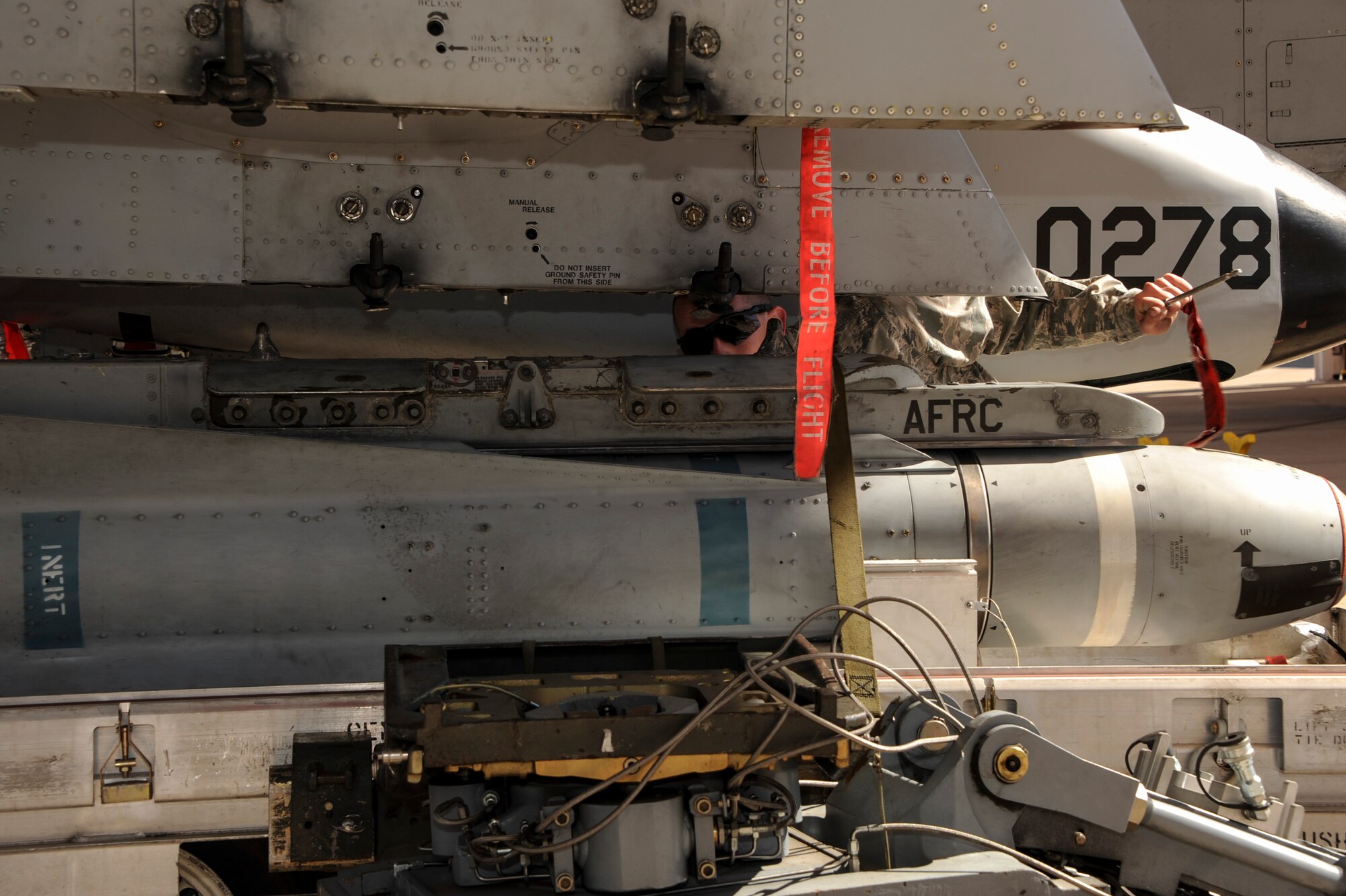 A U.S. Airman from the 924th Maintenance Squadron directs a fellow weapons load crew member while positioning an AGM-65 Maverick missile onto an A-10C Thunderbolt II during a load crew of the year competition at Davis-Monthan Air Force Base, Ariz., Feb. 5, 2016. The objective of the competition is to determine which team can load an A-10 with munitions the fastest with the least deficiencies. (U.S. Air Force photo by Airman Basic Nathan H. Barbour/Released)