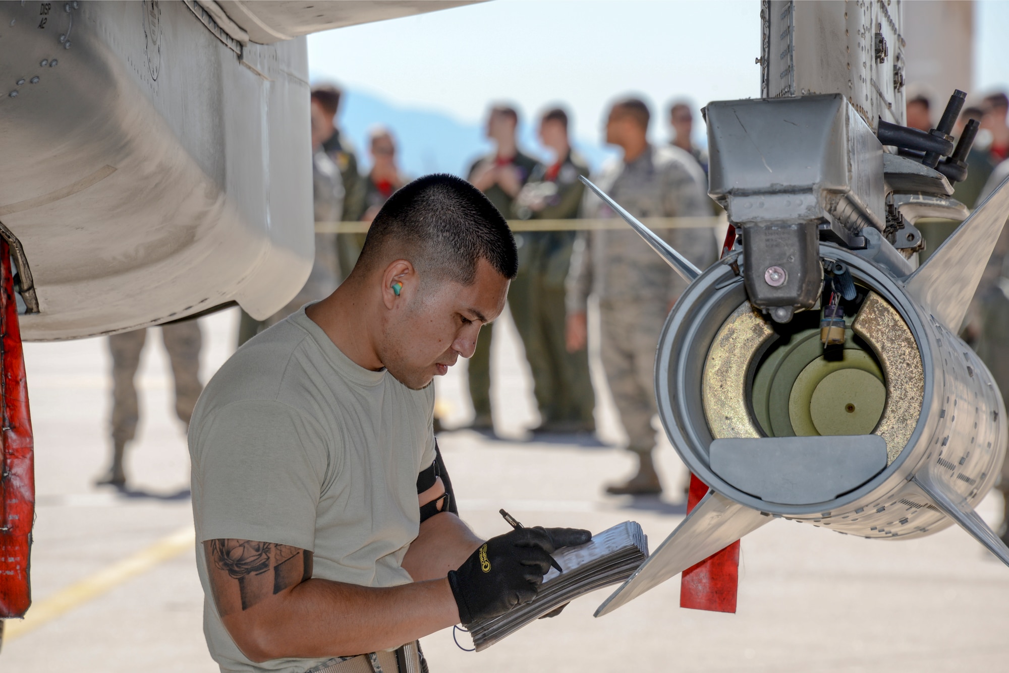 U.S. Air Force Staff Sgt. Virine Salas, 354th Aircraft Maintenance Unit weapons load crew chief, reviews a checklist during a load crew of the year competition on the flightline at Davis-Monthan Air Force Base, Ariz., Feb. 5, 2016. The load crews that participated in this year’s LCOY competition were the winners of last year’s load crew of the quarter competitions.  (U.S. Air Force Photo by Senior Airman Chris Massey/Released)