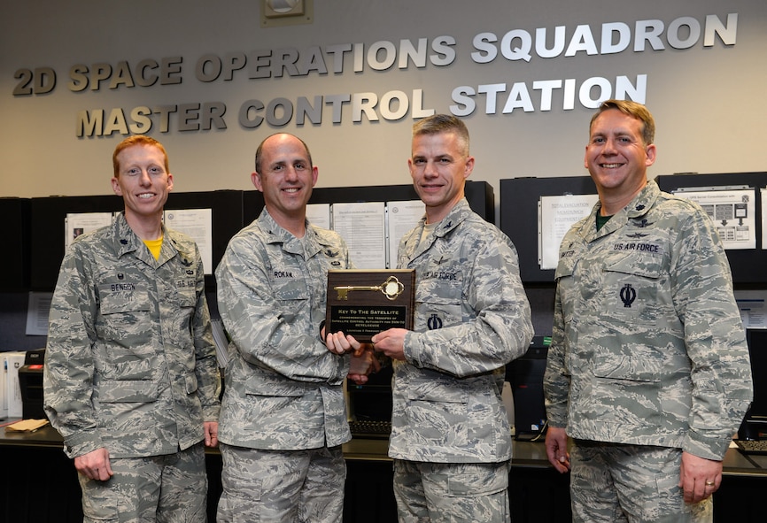 Lt. Col. Todd Benson, 2nd Space Operations Squadron commander, Col. Michael Rokaw, Space and Missile Systems Center’s  GPS Space Segment Division chief, Col. Stephen Slade, Individual Mobilization Augmentee to the 50th Space Wing commander, and Lt. Col. Samuel Baxter, 19th Space Operations Squadron commander, pose with a symbolic key after the 50th Space Wing assumed satellite control authority of SVN-70, a GPS IIF-12 satellite, from 14th Air Force (Air Forces Strategic) in a short ceremony Feb. 12 at Schriever Air Force Base, Colo. This satellite is the last in a demanding schedule of IIF satellite launches; the units have teamed together to support six launches in just 18 months.  (U.S. Air Force photo/Christopher DeWitt)