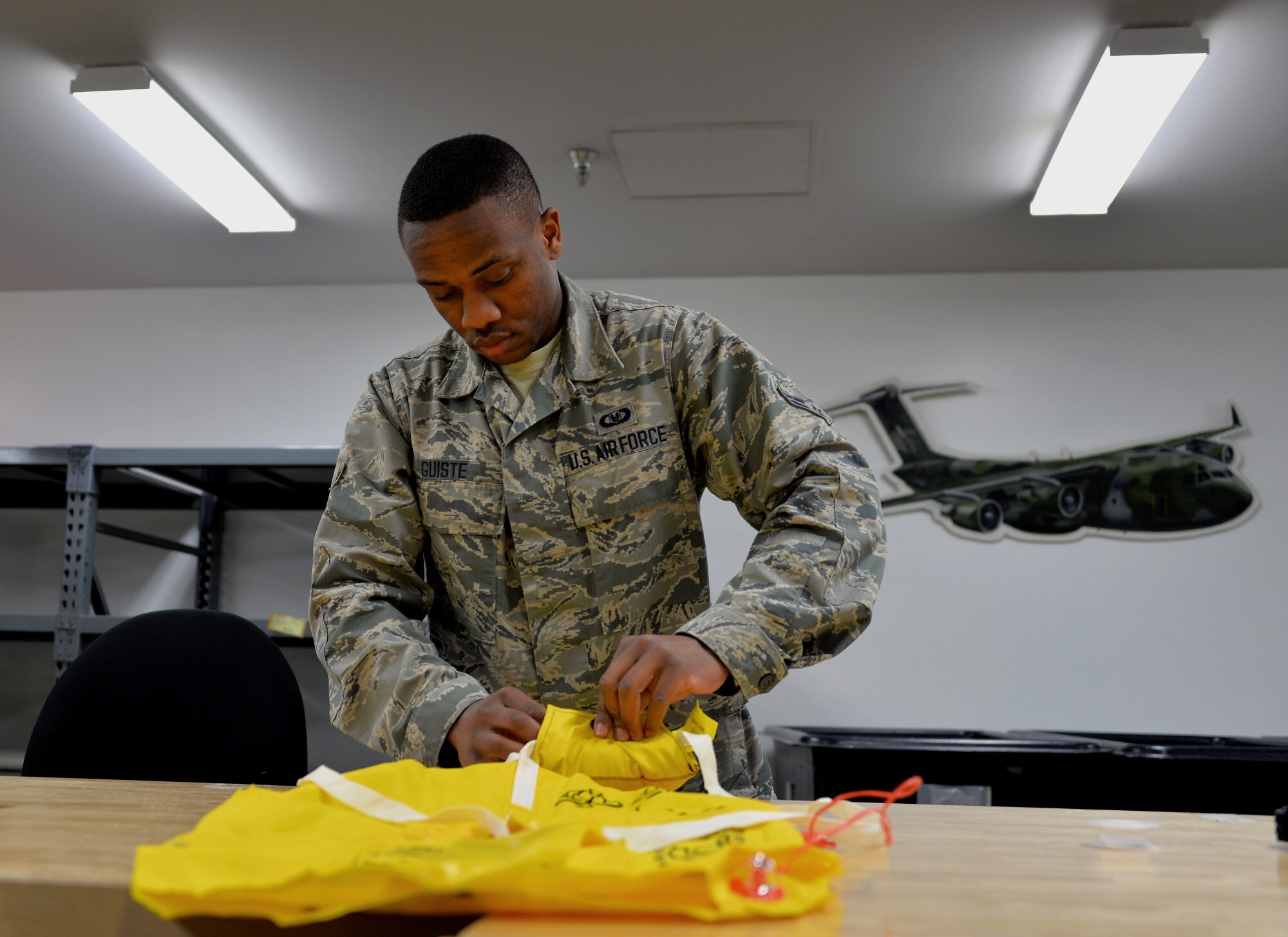 Airman 1st Class Leroy Guiste, 60th Operations Support Squadron aircrew flight equipment journeyman, performs a functional check of a life jacket Feb. 10, 2016, at Travis Air Force Base, California. AFE specialists make sure aircrew have the supplies necessary for any situation. From packing emergency items such as parachutes and survival kits to maintaining regularly used items like flight helmets and oxygen masks, the attention to detail provided by these professionals could mean the difference between life and death. (U.S. Air Force photo by Staff Sgt. Charles Rivezzo)