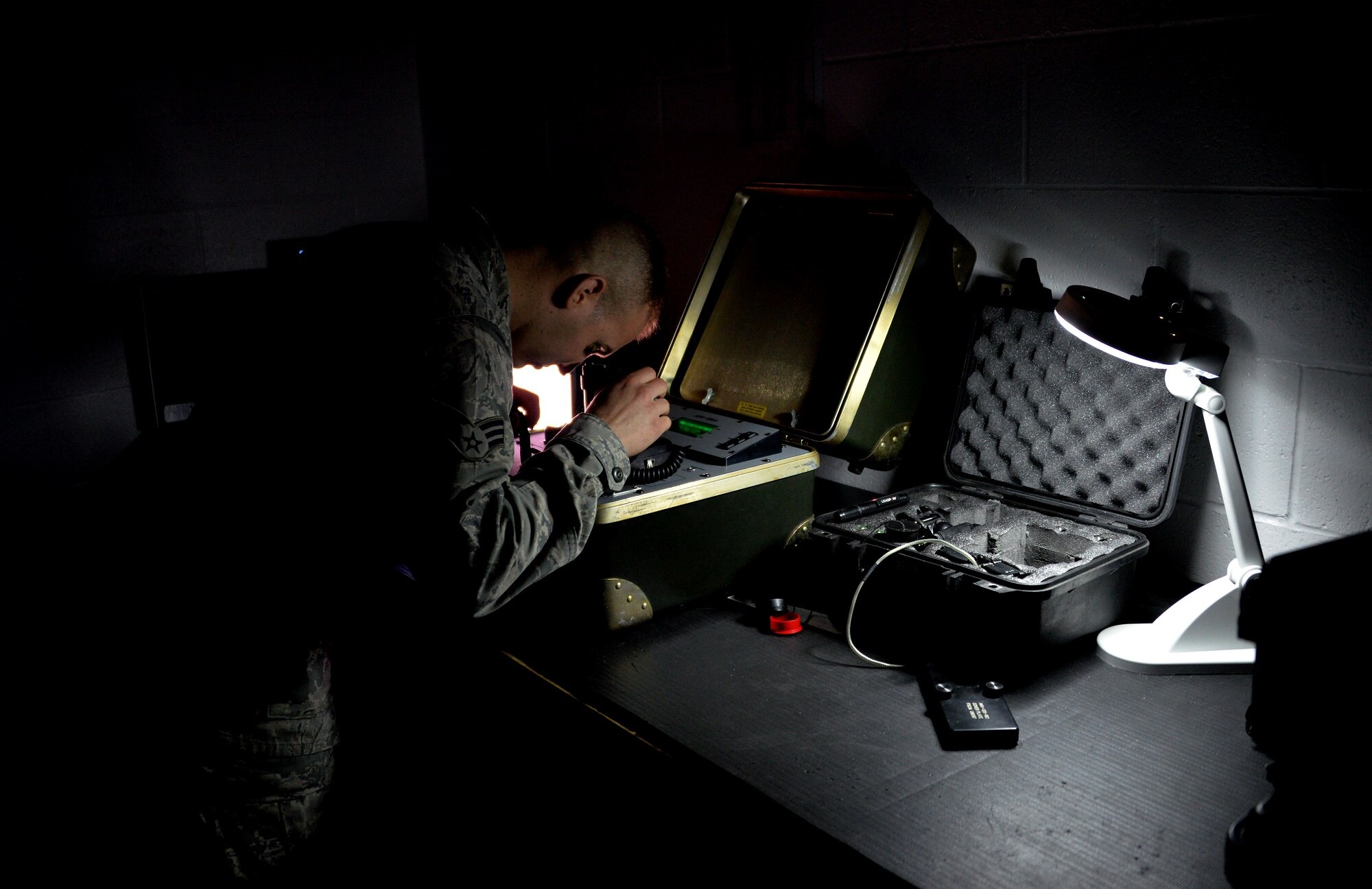 Senior Airman Travis Long, 60th Operations Support Squadron aircrew flight equipment journeyman, checks the functionality of a pair of night vision goggles Feb. 10, 2016, at Travis Air Force Base, California. AFE Airmen inspect, maintain and service all aircrew’s gear to ensure it is in working order and has no discrepancies. (U.S. Air Force photo by Staff Sgt. Charles Rivezzo)
