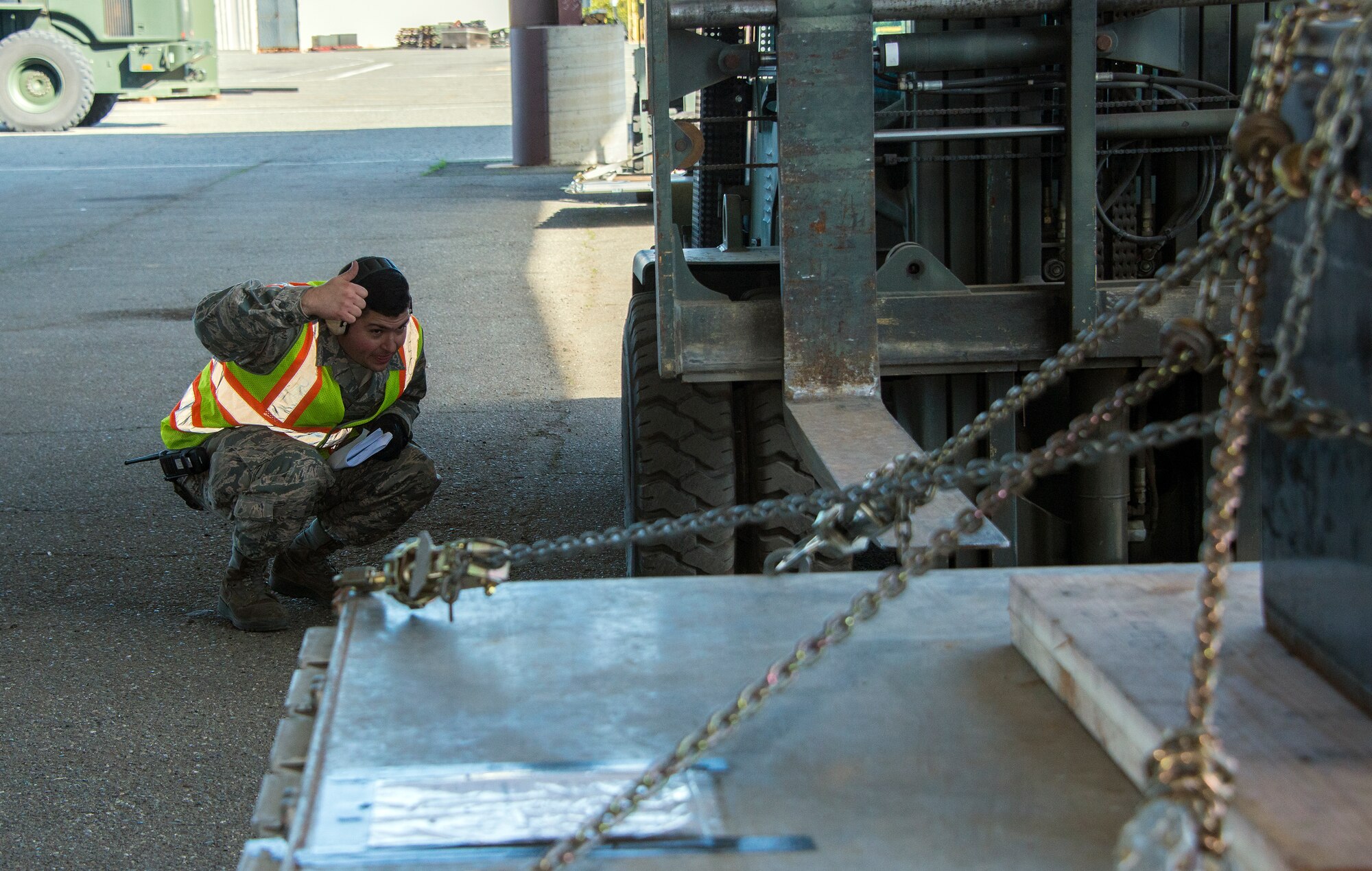 An Airman from the 60th Aerial Port Squadron directs the forklift to readjust its position Feb. 4 before safely setting down a pallet to be weighed and checked. (U.S. Air Force photo by Heide Couch)