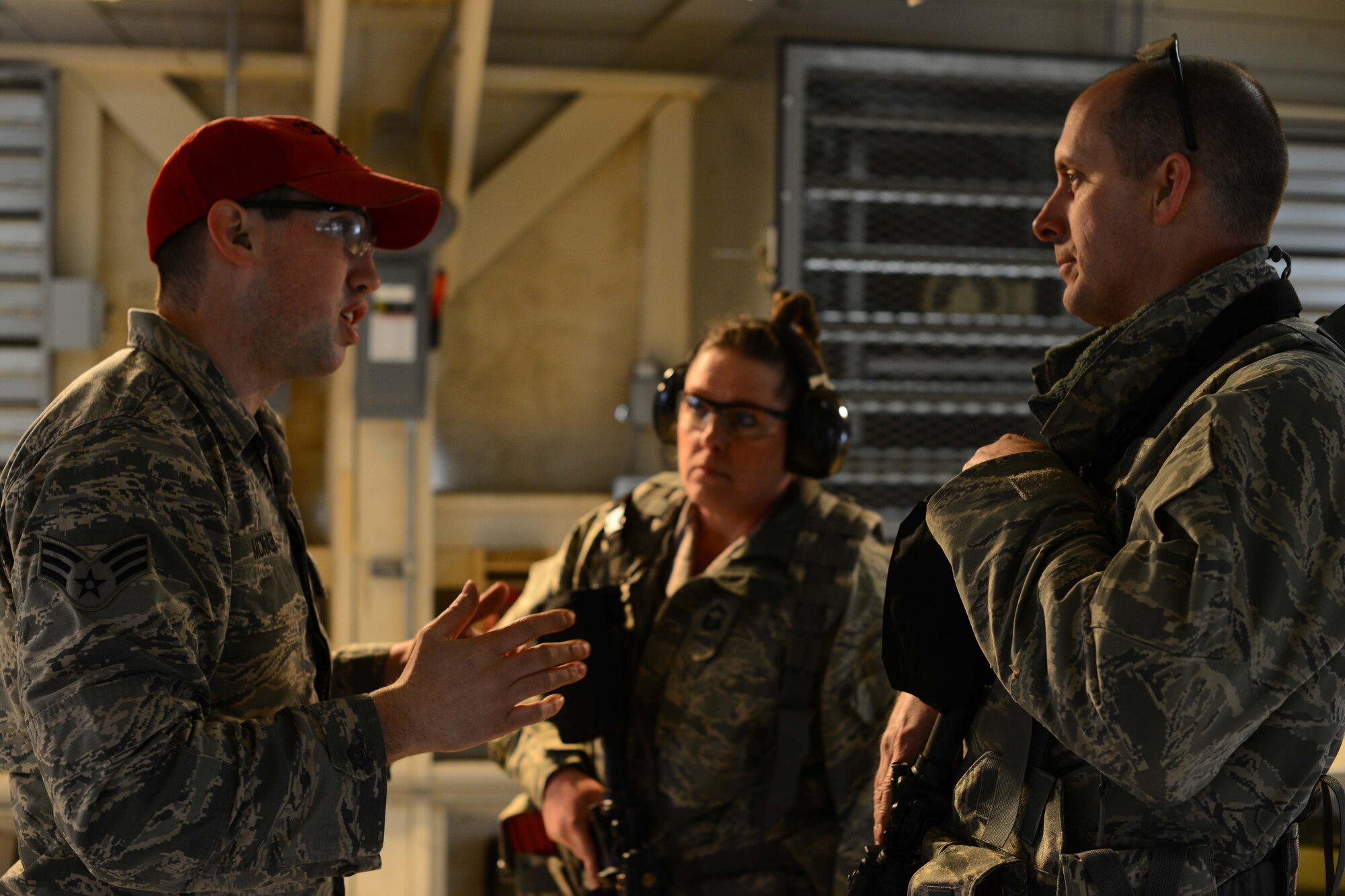 Senior Airman Robert McNabb, 184th Security Forces Squadron combat arms instructor, trains Maj. Trenton Shepherd, 184th SFS commander, and Senior Master Sgt. Stacie Smith, 184th SFS superintendent, for their annual qualifications. Annual qualifications are necessary to maintain marksmanship and familiarity with firearms techniques. (U.S. Air Force photo/Airman 1st Class Christopher Thornbury)