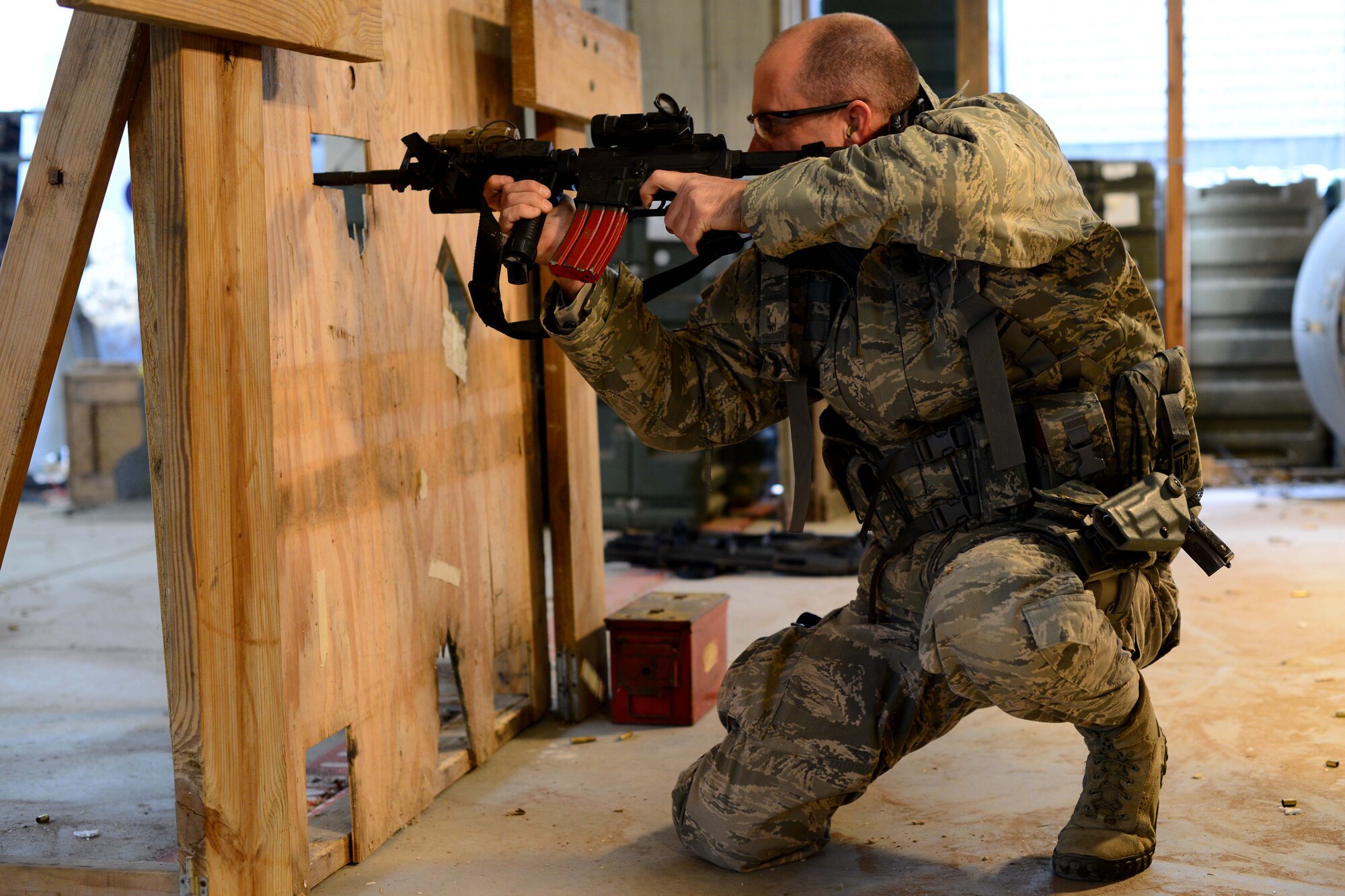 Maj. Trenton Shepherd, 184th Security Forces Squadron commander, fires an M-4 carbine through a barricade during an annual qualifications course. Annual qualifications are necessary to maintain marksmanship and familiarity with firearms techniques. (U.S. Air Force photos/Airman 1st Class Christopher Thornbury)