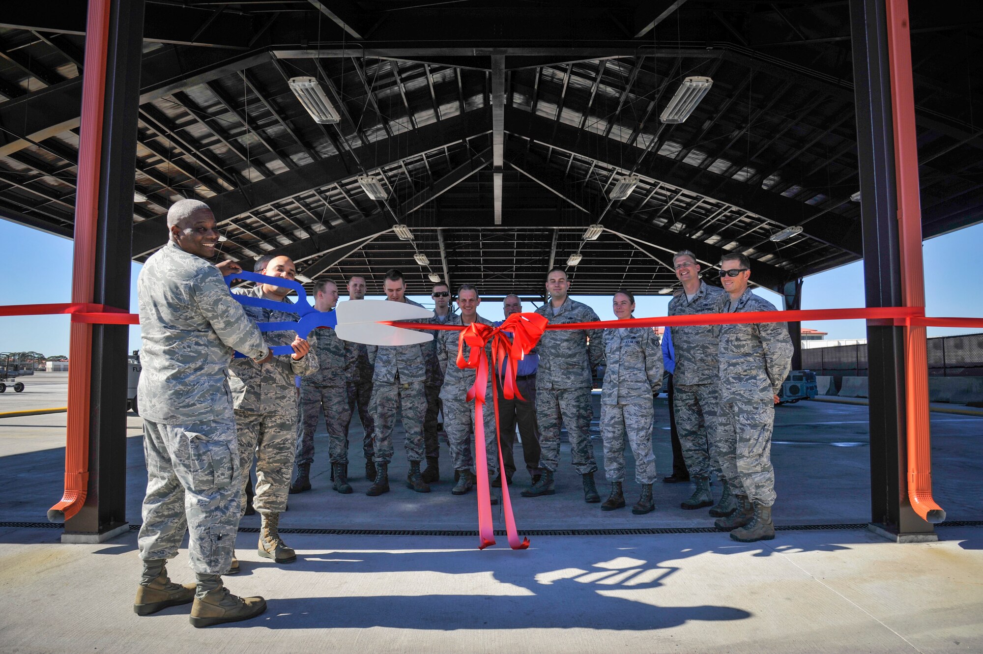 Col. Reginald Godbolt, commander of the 6th Maintenance Group (MXG), and Master Sgt. Scott Marshall, aerospace ground equipment (AGE) flight chief with the 6th MXG, cut a ribbon celebrating the completion of three “quality of life” improvement projects for AGE at MacDill Air Force Base, Fla., Feb. 11, 2016. The AGE shop received two new overhangs and air conditioning in their maintenance bay. (U.S. Air Force photo by Senior Airman Ned T. Johnston)