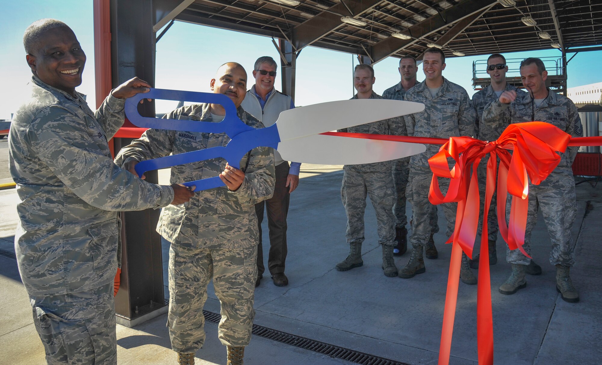 Col. Reginald Godbolt, commander of the 6th Maintenance Group (MXG), and Master Sgt. Scott Marshall, aerospace ground equipment (AGE) flight chief with the 6th MXG, cut a ribbon celebrating the completion of three “quality of life” improvement projects for AGE at MacDill Air Force Base, Fla., Feb. 11, 2016. The AGE shop received two new overhangs and air conditioning in their maintenance bay. (U.S. Air Force photo by Senior Airman Ned T. Johnston)