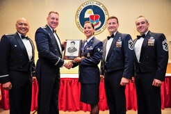 Col. Jimmy Canlas (left), 437th Airlift Wing vice commander, Col. Robert Lyman, Joint Base Charleston commander, Chief Master Sgt. Mark Bronson, 628th Air Base Wing command chief and Chief Master Sgt. Kristopher Berg, 437th Airlift Wing command chief, congratulate Senior Airman Marisa Cobb, 628th Security Forces Squadron Phoenix Raven, for receiving the John L. Levitow Award during an Airman Leadership School graduation ceremony Feb. 11, 2016, at Joint Base Charleston – Air Base, S.C. The Levitow award is the highest honor bestowed during ALS and is awarded to the Airman who displays the highest level of leadership qualities. (U.S. Air Force photo/Airman 1st Class Thomas T. Charlton)