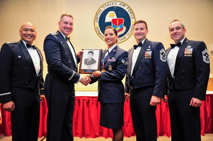 Col. Jimmy Canlas (left), 437th Airlift Wing vice commander, Col. Robert Lyman, Joint Base Charleston commander, Chief Master Sgt. Mark Bronson, 628th Air Base Wing command chief and Chief Master Sgt. Kristopher Berg, 437th Airlift Wing command chief, congratulate Senior Airman Marisa Cobb, 628th Security Forces Squadron Phoenix Raven, for receiving the John L. Levitow Award during an Airman Leadership School graduation ceremony Feb. 11, 2016, at Joint Base Charleston – Air Base, S.C. The Levitow award is the highest honor bestowed during ALS and is awarded to the Airman who displays the highest level of leadership qualities. (U.S. Air Force photo/Airman 1st Class Thomas T. Charlton)