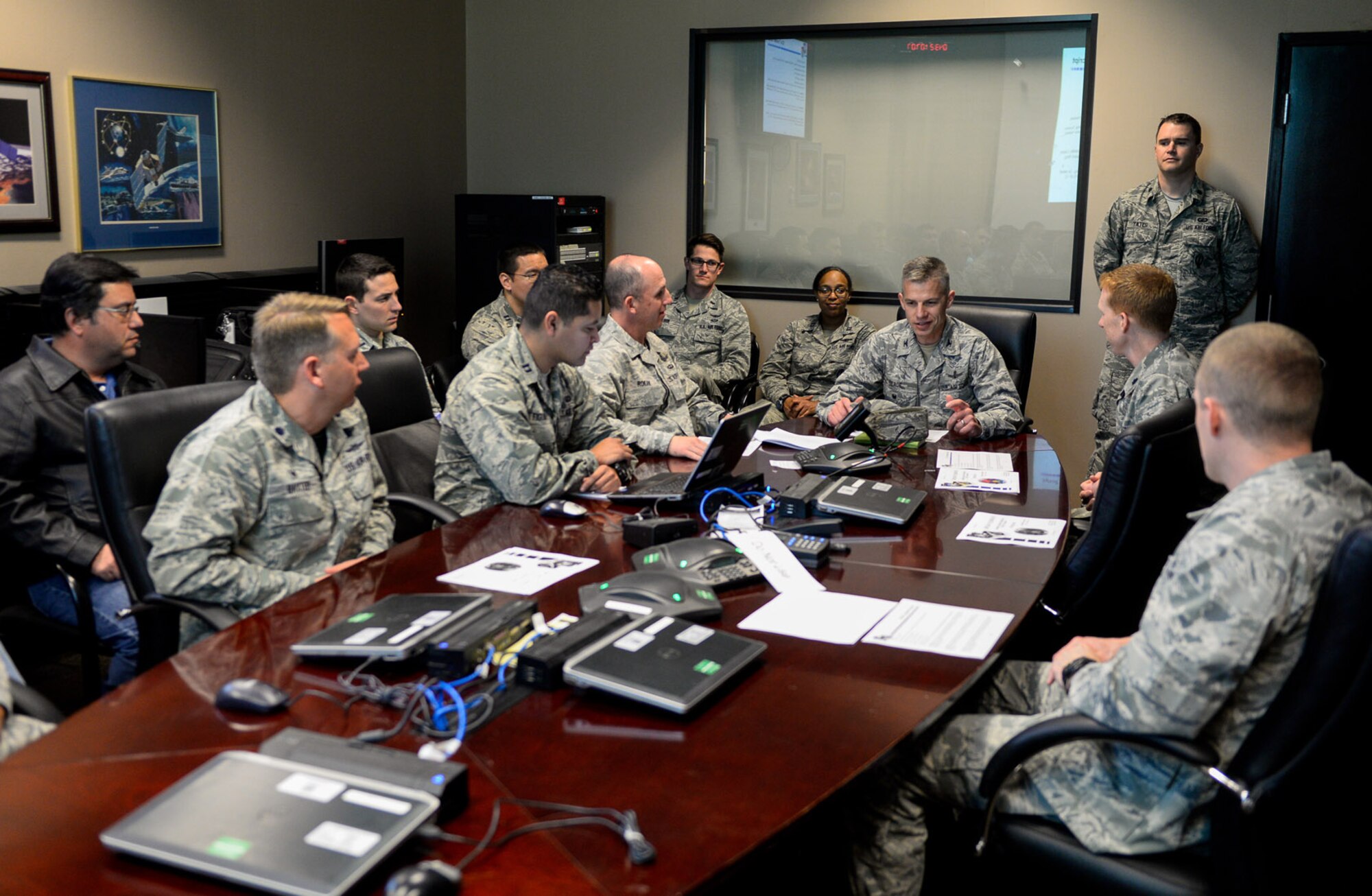 Col. Stephen Slade, Individual Mobilization Augmentee to the 50th Space Wing commander, assumes control of SVN-70, a GPS IIF-12 satellite, from 14th Air Force (Air Forces Strategic) during a ceremony on Feb. 12 at Schriever Air Force Base, Colo. GPS IIF-12 (SVN-70) will replace the legacy SVN-41, which will be moved to another location and provide auxiliary support to the GPS constellation. (U.S. Air Force photo/Christopher DeWitt)