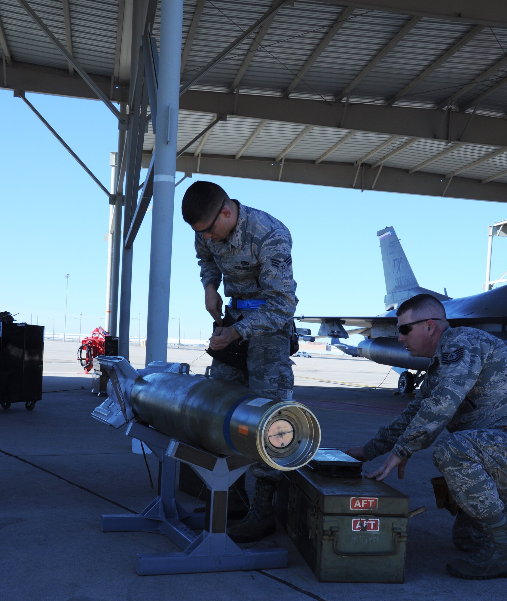 Airmen from the 301st Aircraft Maintenance Squadron work to complete munitions preparation Feb. 7, during a weapons load competition here. Four, three-member teams competed in this year’s competition, which included a written exam, uniform inspection, and load task. The competition helps Airmen work quickly and effectively to make an F-16 Fighting Falcon weapons ready in minutes. (U.S. Air Force photo by Staff Sgt. Melissa Harvey)