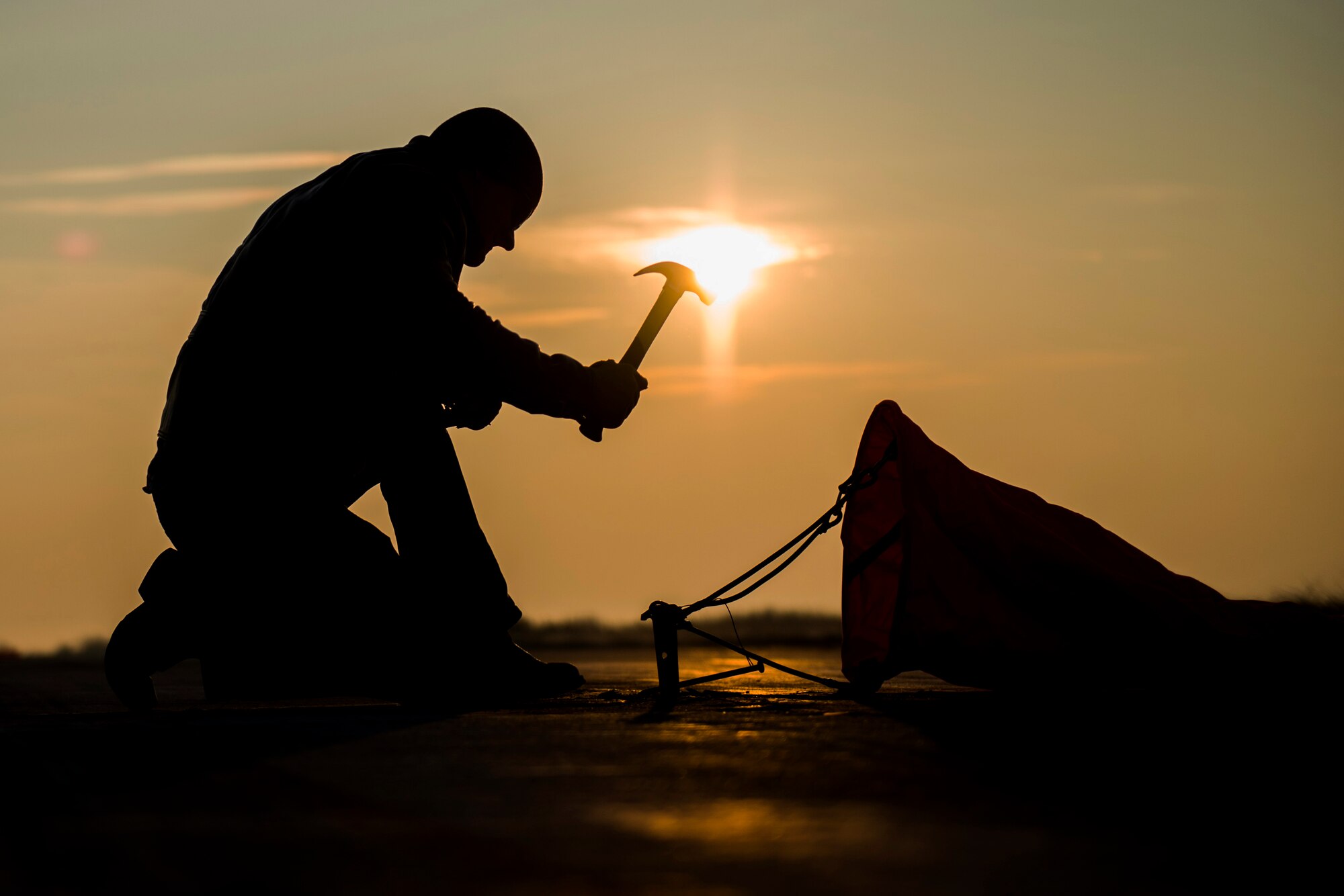 A 321st Special Tactics Squadron combat controller hammers into place a distance marker before the start of an austere landing exercise at Plovdiv, Bulgaria, Feb. 9, 2016. Combat controllers supported the training for multiple aircraft deployed to Bulgaria as part of Operation Atlantic Resolve which aims to assure the U.S.’s commitment to the security and stability of Europe. (U.S. Air Force photo by Airman 1st Class Luke Kitterman/Released)