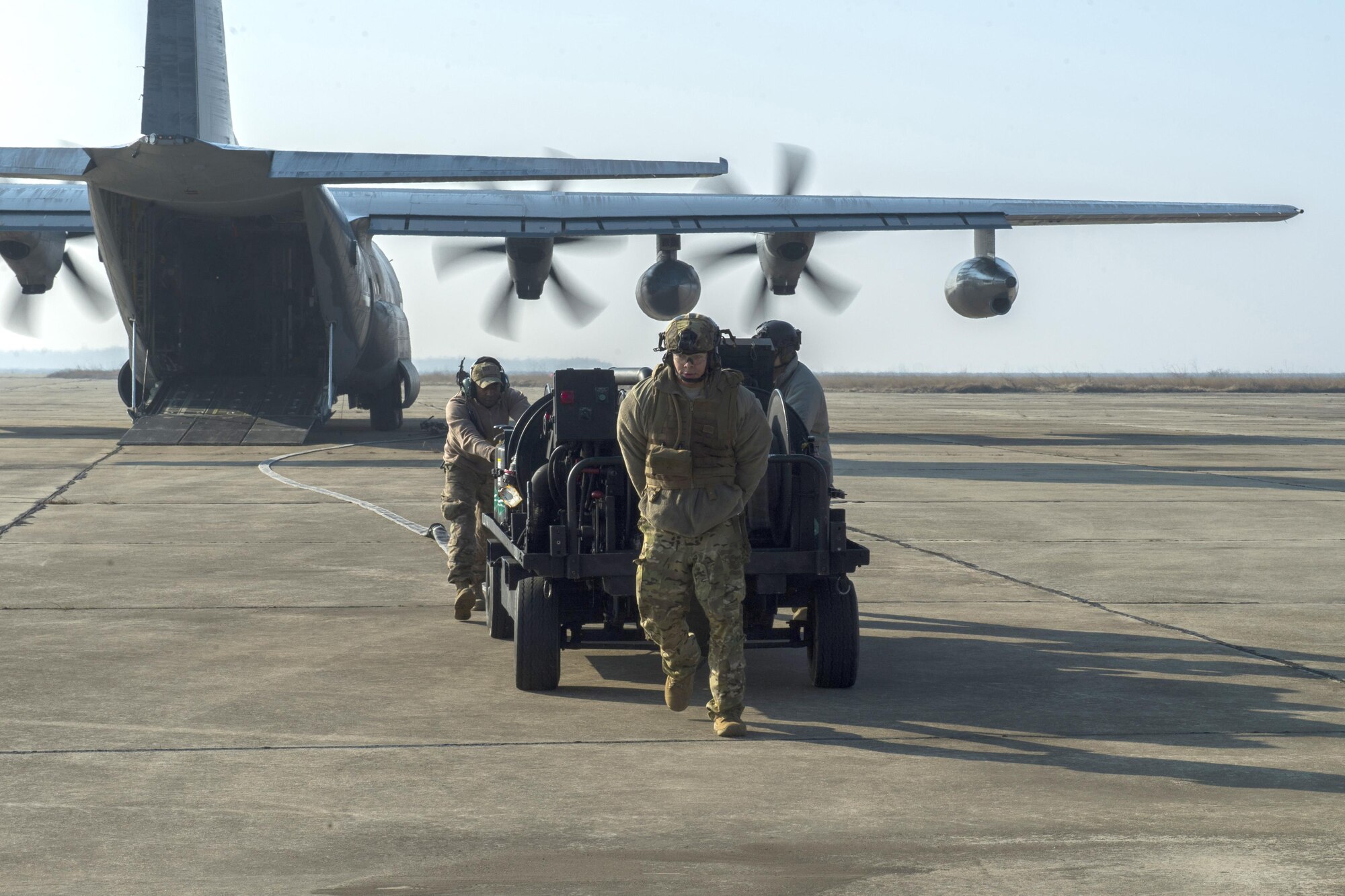 Members of the 100th Logistics Readiness Squadron move a forward area manifold cart out of the back of an MC-130J Commando II, assigned to the 67th Special Operations Squadron, during forward area refueling point training at Plovdiv, Bulgaria, Feb. 9, 2016. The FAM cart weighs approximately 3,500-lbs. and is mainly extracted from the aircraft. (U.S. Air Force photo by Airman 1st Class Luke Kitterman/Released)