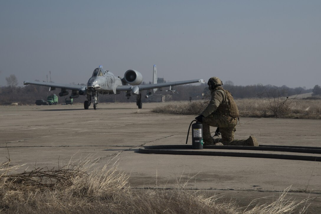 A 74th Expeditionary Fighter Squadron A-10C Thunderbolt II aircraft taxis toward a member of 100th Logistics Readiness Squadron during forward area refueling point training at Plovdiv, Bulgaria, Feb. 9, 2016. FARP is used to provide fuel to rotary and fixed-wing aircraft at remote ground locations. (U.S. Air Force photo by 1st Lt Chris Sullivan/Released)