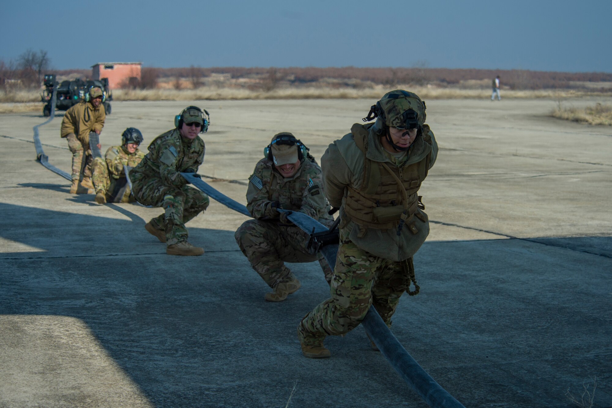 Airmen clear remaining fuel in a hose back into an MC-130J Commando II, assigned to the 67th Special Operations Squadron, during forward area refueling point training at Plovdiv, Bulgaria, Feb. 9, 2016. The C-130 can provide fuel to multiple aircraft in the air or on the ground with the FARP team. (U.S. Air Force photo by Airman 1st Class Luke Kitterman/Released)