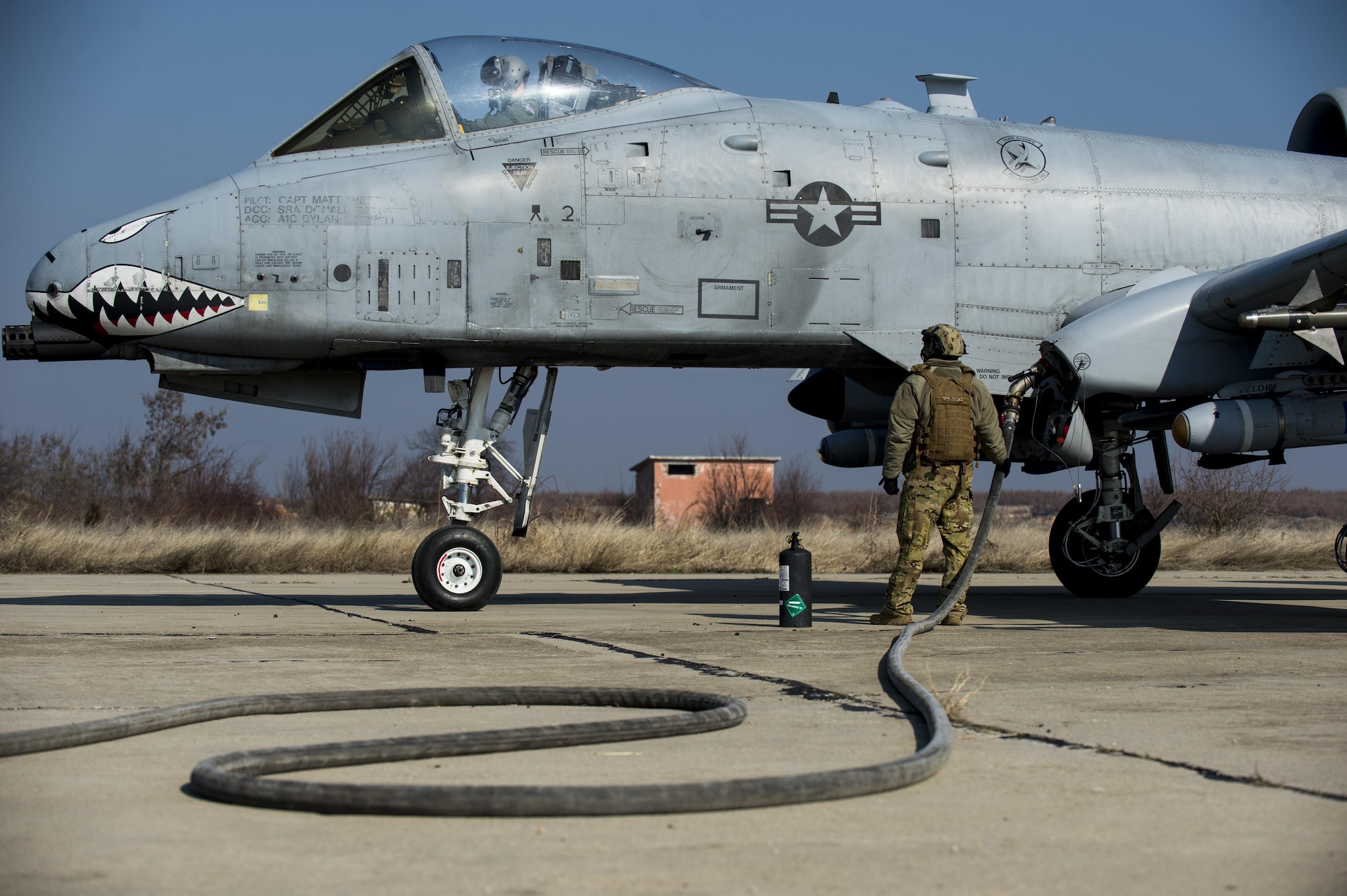 A member of the 100th Logistics Readiness Squadron refuels a 74th Expeditionary Fighter Squadron A-10C Thunderbolt II aircraft during forward area refueling point training at Plovdiv, Bulgaria, Feb. 9, 2016. A single A-10 usually receives approximately 2,000 pounds of fuel in a four-to-five-minute span during FARP training while a C-130 aircraft can provide tens of thousands of pounds of fuel if needed. (U.S. Air Force photo by Airman 1st Class Luke Kitterman/Released)