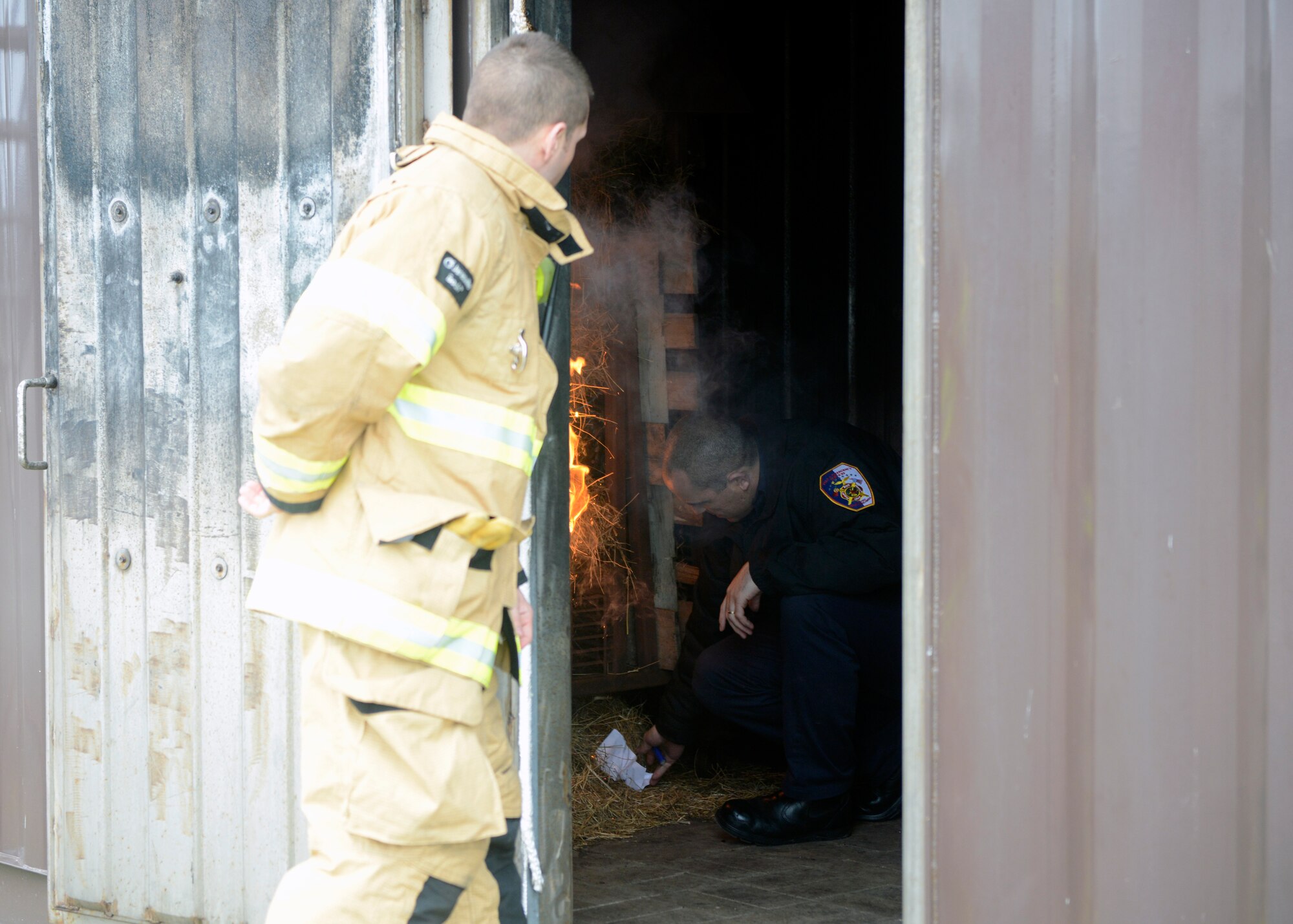 Firefighters from the 65th Civil Engineer Squadron start a structural fire at their training facility on Lajes Field, Azores, Feb. 6, 2016. The training was designed to prepare newly hired Portuguese locals. Lajes Field, operated by the 65th Air Base Group, became a geographically separated unit of the 86th Airlift Wing in August, 2015. (U.S. Air Force photo/Tech. Sgt. Kristopher Levasseur)