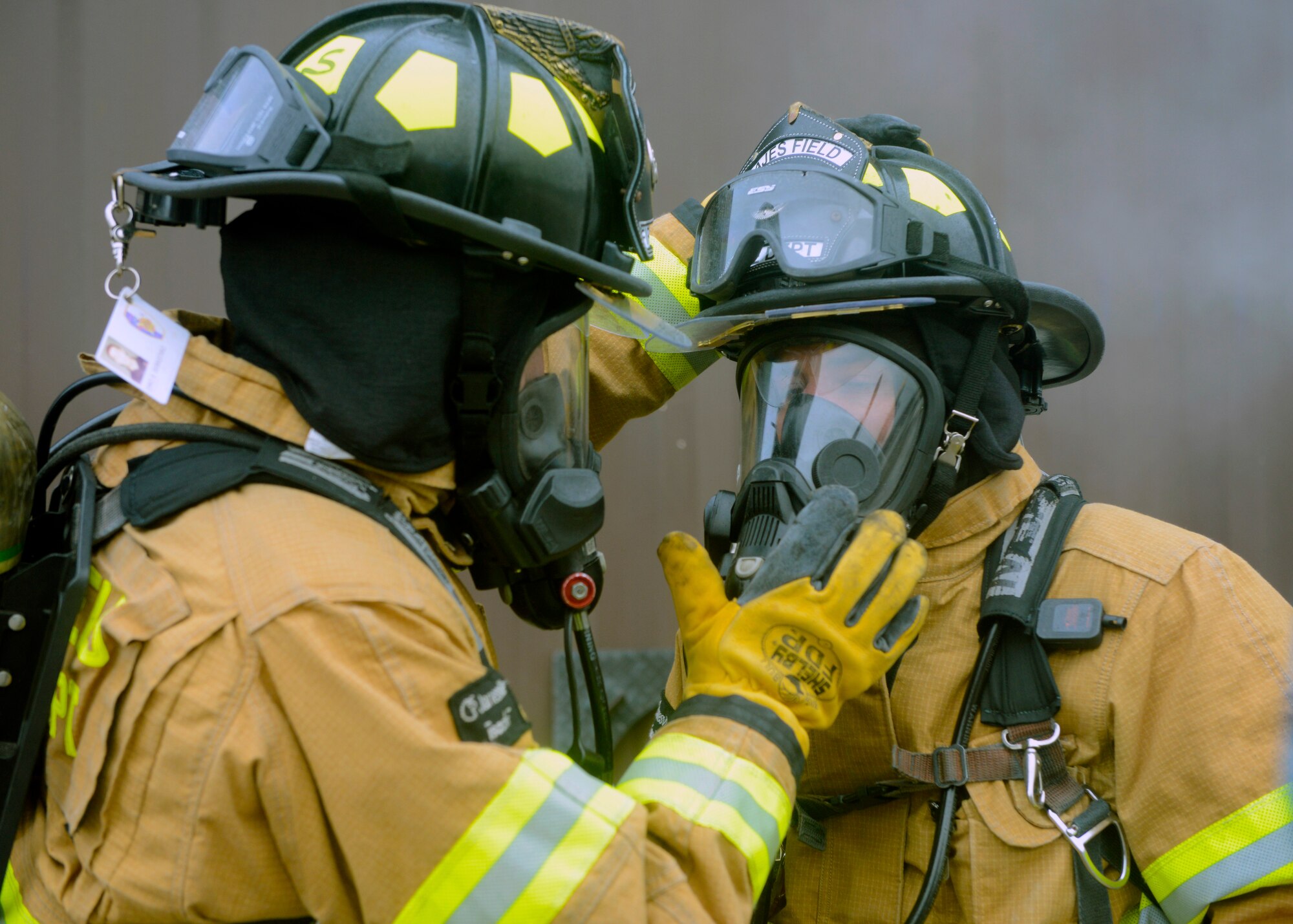 Firefighters from the 65th Civil Engineer Squadron test the seal of their oxygen masks before combatting a structural fire at their training facility on Lajes Field, Azores, Feb. 6, 2016. The training was designed to prepare newly hired Portuguese locals. Lajes Field, operated by the 65th Air Base Group, became a geographically separated unit of the 86th Airlift Wing in August, 2015. (U.S. Air Force photo/Tech. Sgt. Kristopher Levasseur)