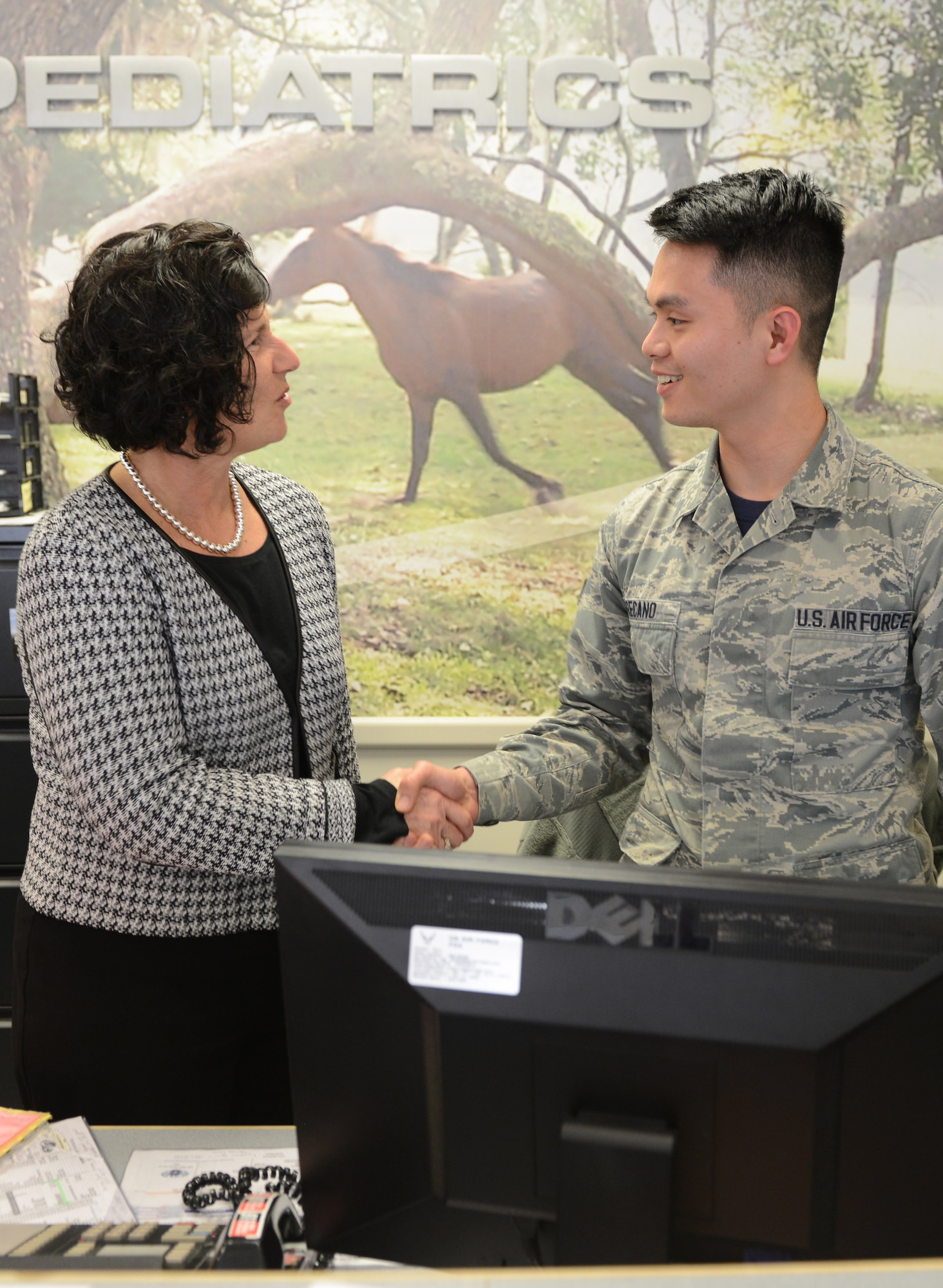 Morro is greeted by Senior Airman Jan Ronel Recano, 78th Medical Operations Squadron technician, during the facility tour. (U.S. Air Force photo by Tommie Horton)