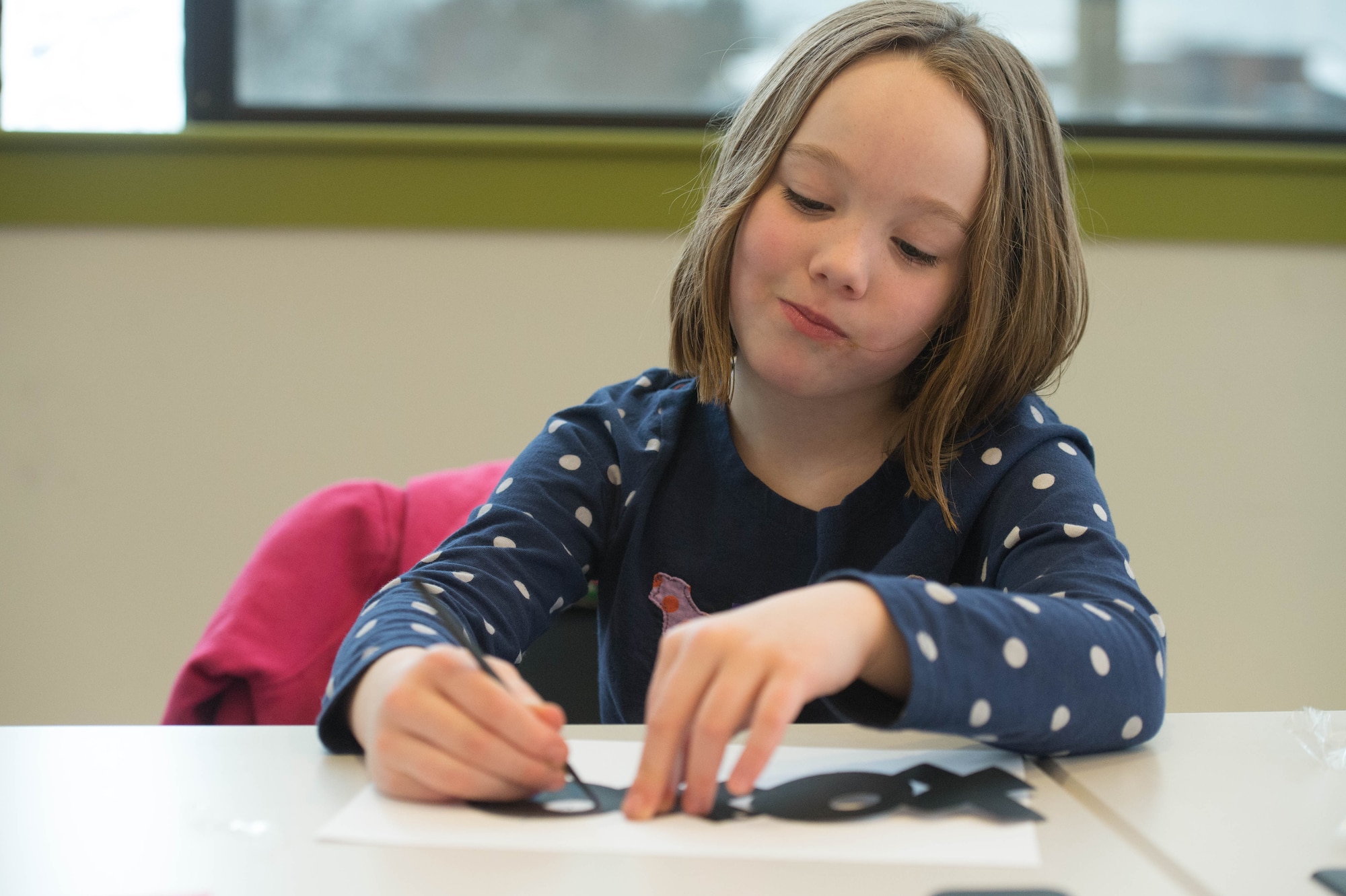 Lola Gervin creates a Valentine’s Day gift for her father during a Valentine's Day craft event at the Information Learning Center Feb 9. The event was hosted by the ILC as part of their support to the Hanscom community. (U.S. Air Force photo by Jerry Saslav)