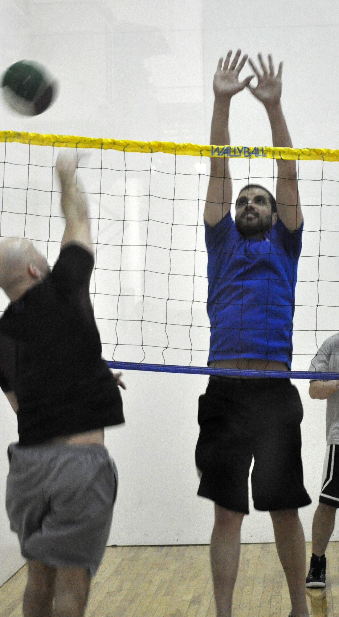 Anthony Gutierrez leaps to block during the 10-team wallyball tournament Jan. 28 at the Gerrity Fitness Center. John Truong, Kyle Barton and Thomas Nguyen of Lights Out won the final match against 76 CMXG. (Air Force photo by John Parker/Released)