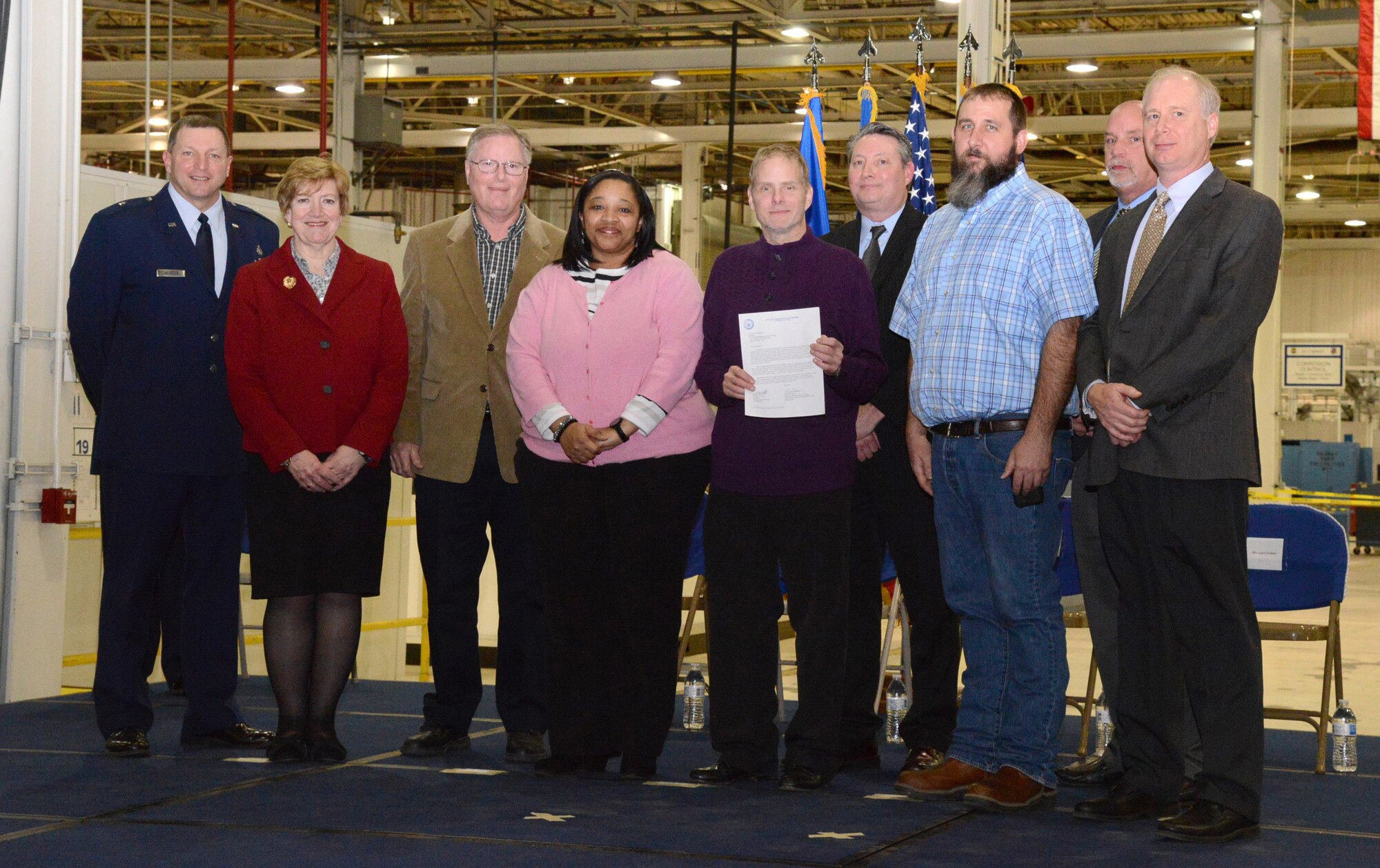 The 76th Software Maintenance Group received a recertification letter during the VPP Celebration. Pictured are, from left, Brig. Gen. Mark K. Johnson, Maureen Sullivan, Gary Bristol, Stacy Hawthorne, Norman Wagner, David Bates, Christopher Stulken, Carl Dahms and Rick McIver. (Air Force photo by Kelly White/Released)