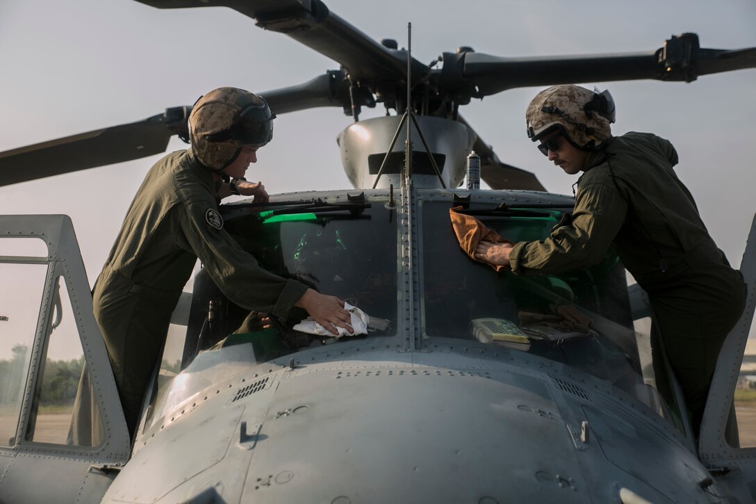 Sgt. Kyle J. Mohr (Left) and Cpl. Erik A. Dudley prepare a UH-1Y Huey for a flight mission during an amphibious demonstration as part of exercise Cobra Gold 16 in Utapao, Thailand, Feb. 12, 2016. Mohr and Dudley must prepare the aircraft for their pilot’s inspection, as well as perform their own inspections, before every flight. The amphibious demonstration is designed to increase naval interoperability and logistics capabilities. Dudley, a Bath, Maine, native, is an aerial observer and flight line mechanic. Mohr, a Two Rivers, Wis., native, is a crew chief. Both Marines are with Light Attack Helicopter Squadron 167, which is currently supporting Marine Aircraft Group 36, 1st Marine Aircraft Wing, III Marine Expeditionary Force, under the unit deployment program. 
