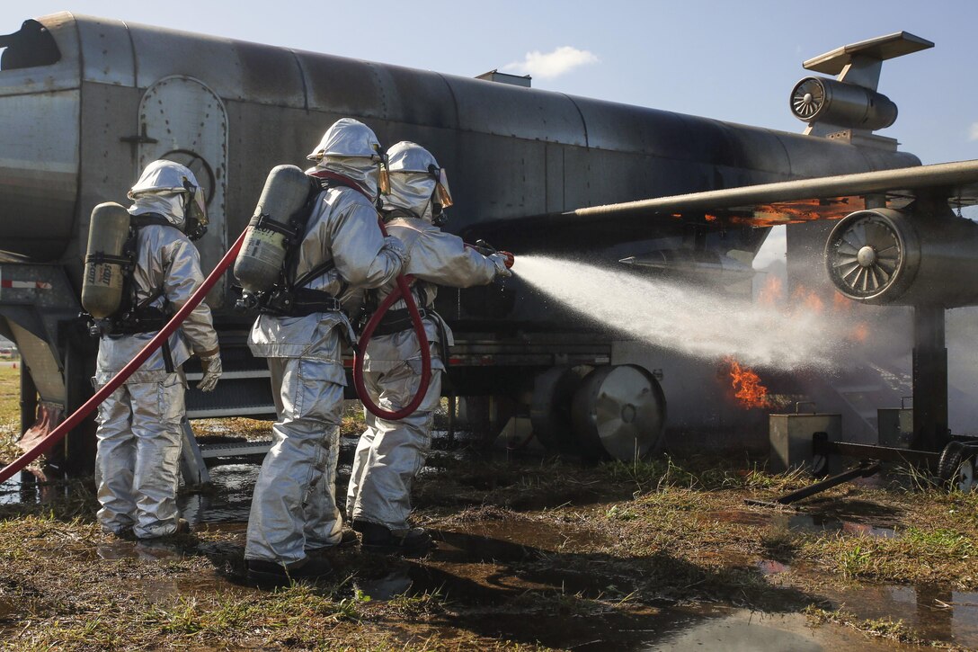 Marines practice fire suppression methods during aircraft rescue firefighting training on Marine Corps Base Hawaii, Feb. 10, 2016. Lance Cpl. Jesus Sepulveda Torre