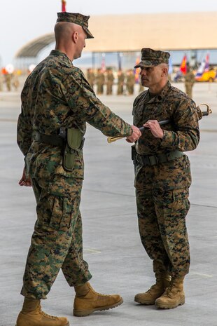 Col. Daniel Shipley, left, Marine Aircraft Group 12 commanding officer, passes the noncommissioned officer sword to Sgt. Maj. Miguel A. Ortega, newly appointed MAG-12 sergeant major, during a relief and appointment ceremony at Marine Corps Air Station Iwakuni, Japan, Feb. 5, 2016. This ceremony symbolizes the end of Sgt. Maj. Sergio MartinezRuiz’s tour after assuming the role of MAG-12’s sergeant major in May of 2014.