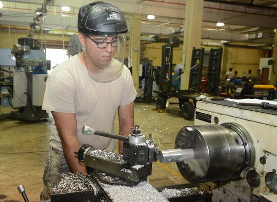 Senior Airman Alex Villanueva, 36th Maintenance Squadron aircraft metals technology journeyman, uses a lathe machine to turn down a piece of metal Feb. 2, 2016, at Andersen Air Force Base, Guam. The aircraft metals technology section consist of machinists and welders responsible for anything that entails small intricate parts that needs to be extremely accurate down to a thousandths of an inch. (U.S. Air Force photo/Airman 1st Class Arielle Vasquez)