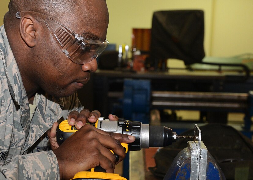 Senior Airman Chandler Brown, 36th Maintenance Squadron aircraft structural maintenance journeyman, drills a hole into a piece of sheet metal Feb. 2, 2016, at Andersen Air Force Base, Guam. The aircraft structural maintenance section is responsible for the structural maintenance and corrosion control on transient and deployed aircraft, which includes inspecting, repairing, painting and removal of corrosion on support equipment. (U.S. Air Force photo/Airman 1st Class Arielle Vasquez)