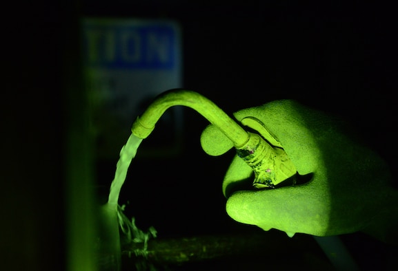 Tech. Sgt. Juanita Davis, 36th Maintenance Squadron non-destructive inspection specialist, uses a magnetic particle machine to detect cracks in a piece of metal, which could potentially damage aircraft Feb. 3, 2016, at Andersen Air Force Base, Guam. The 36th MXS NDI lab uses high-tech equipment to perform operations on aircraft to ensure Airman safety, cost-effectiveness and mission success. (U.S. Air Force photo/Airman 1st Class Arielle Vasquez)