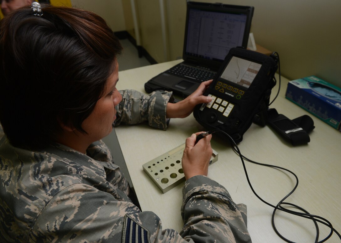 Staff Sgt. Mary Vitte, 36th Maintenance Squadron non-destructive inspection specialist, calibrates an eddy current machine, Feb. 3, 2016, at Andersen Air Force Base, Guam. If there are any defects it will cause a change in the magnetic field which is indicated by a spike or change in signal on the display screen. (U.S. Air Force photo/Airman 1st Class Arielle Vasquez)