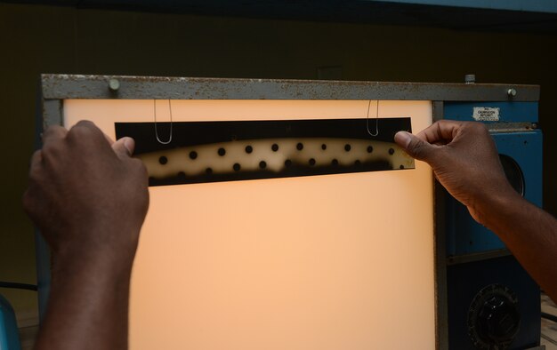 Senior Airman Clarence Tobias, 36th Maintenance Squadron non-destructive inspection specialist, checks an x-ray film of B-52 flaptracks for cracks Feb. 3, 2016, at Andersen Air Force Base, Guam. NDI is responsible for performing inspections of aircraft structural components to identify damages at a microscopic level. (U.S. Air Force photo/Airman 1st Class Arielle Vasquez)