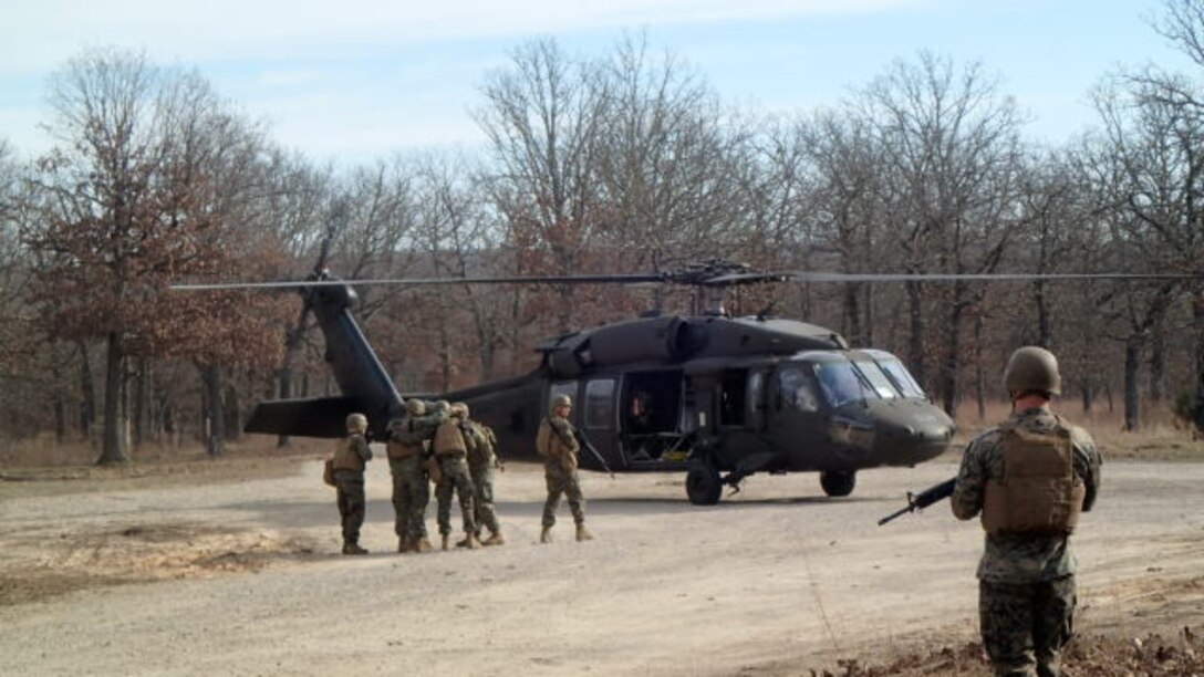 Students hand off detainee after identifying him through biometrics at a check point.     