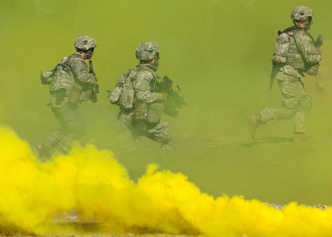 Army paratroopers run through smoke to mask their movements while assaulting an objective at the Peason Ridge area of Fort Polk, La., Feb. 13, 2016. Army photo by Staff Sgt. Sean Brady