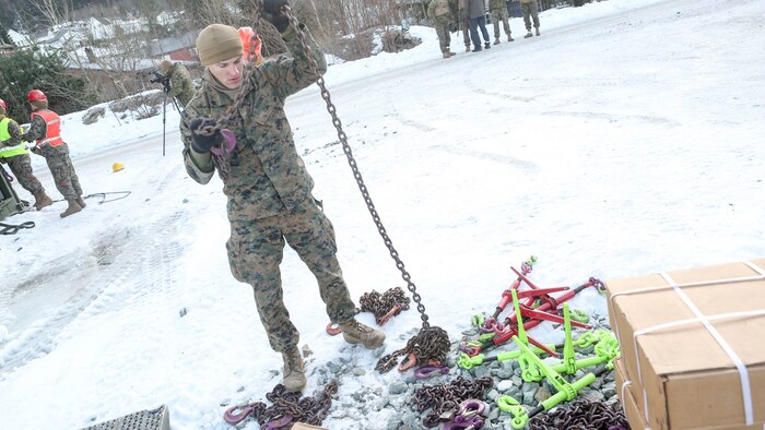 A Marine with 2nd Marine Expeditionary Brigade prepares the tie down chains shortly before transporting multiple vehicles by rail at Hell Station in Hell, Norway Feb. 12, 2016. The rail operations were in preparation for Exercise Cold Response 16, comprised of 13 allied and partner nations, and over 16,000 troops, starting later this month. 