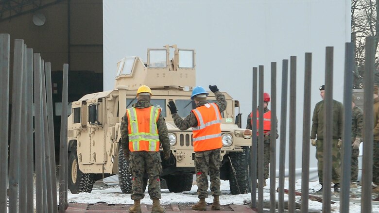Marines with 2nd Marine Expeditionary Brigade guide a Humvee onto a railcar at Hell Station Feb. 12, 2016, for transportation to Rena, Norway, where the 2nd Marine Expeditionary Brigade’s ground combat element will take part in live-fire exercise in the coming days. The rail operations moved vehicles and equipment prepositioned in caves here to the training area in preparation for Exercise Cold Response 16, comprised of 13 allied and partner nations, and over 16,000 troops, starting later this month. 