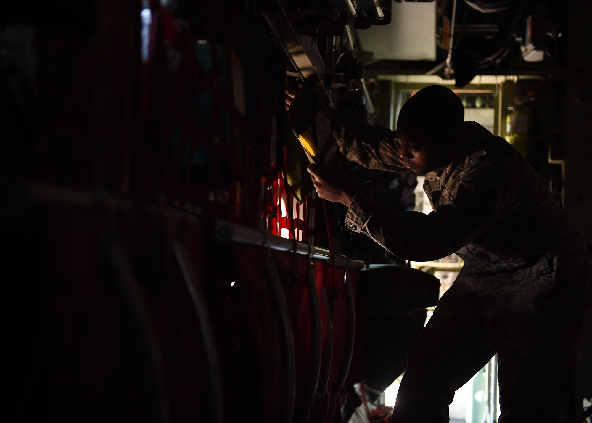 Tech. Sgt. Nafis Beyah, a 386th Expeditionary Operations Support Squadron aircrew flight equipment technician, inspects aircrew safety equipment on-board a C-130H at an undisclosed location in Southwest Asia, Feb. 9, 2016. The aircrew flight equipment team maintains and services survival equipment such as parachutes, oxygen masks, night vision goggles, survival vests and flight helmets. (U.S. Air Force photo by Staff Sgt. Jerilyn Quintanilla) 