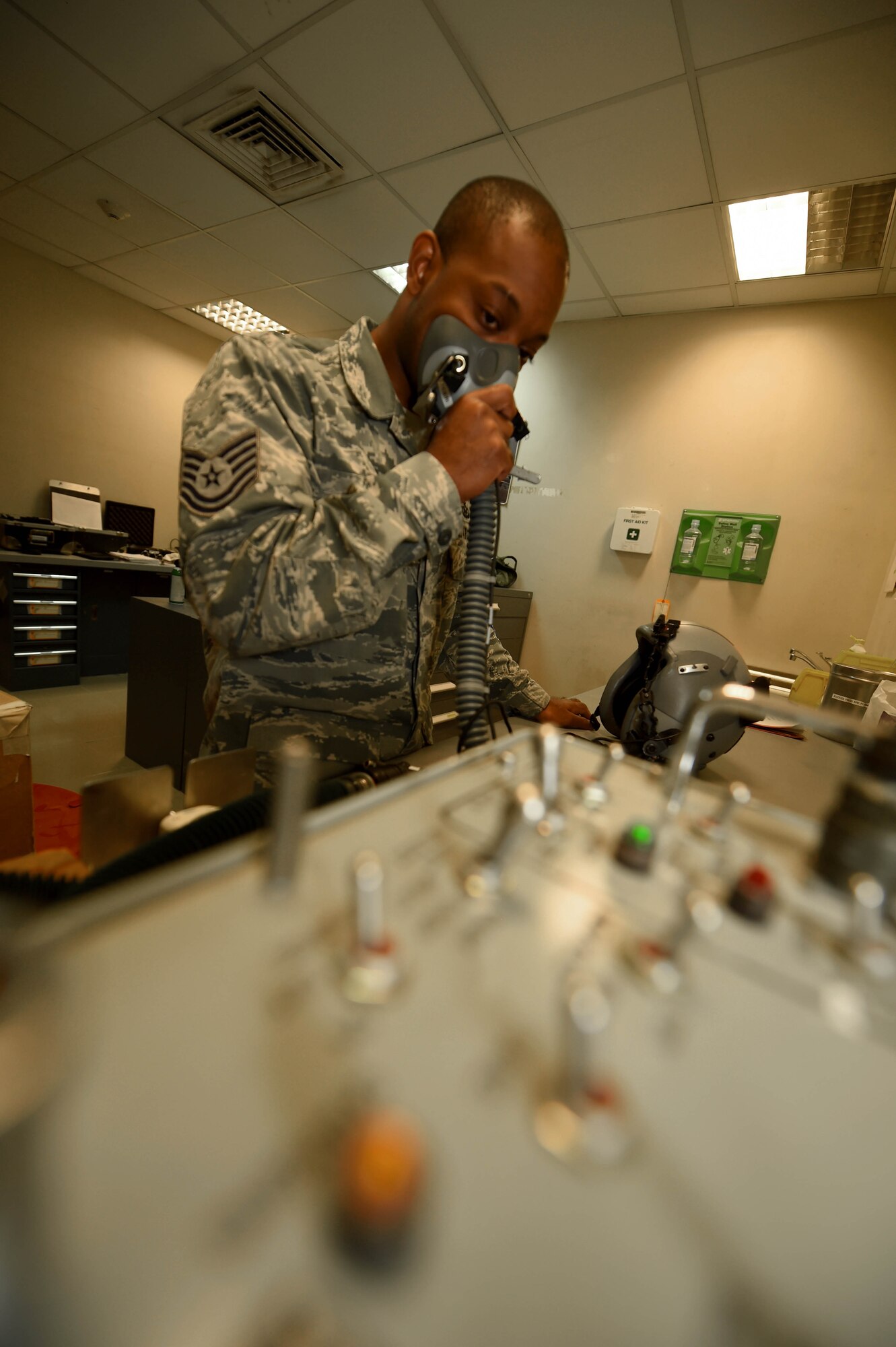 Tech. Sgt. Nafis Beyah, a 386th Expeditionary Operations Support Squadron aircrew flight equipment technician, inspects an MBU 12/p mask at an undisclosed location in Southwest Asia, Feb. 9, 2016. Beyah is part of a 12-person aircrew flight equipment team supporting Operation INHERENT RESOLVE by ensuring all flight and safety equipment is operational and ready to use. (U.S. Air Force photo by Staff Sgt. Jerilyn Quintanilla)