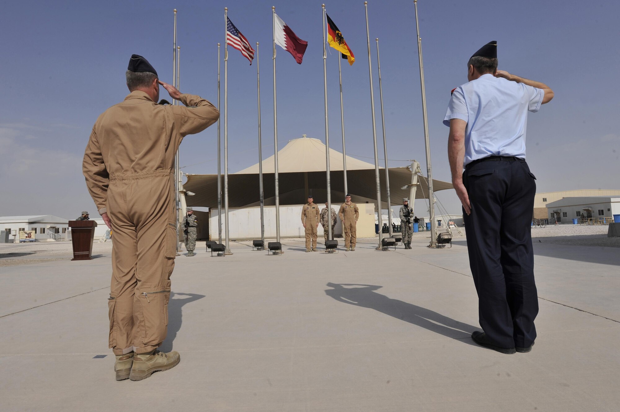 Lt. Gen. Joachim Wundrak (right), commander, German Air Operations Command and German Air Force Col. Gerhard Roubal, salute during a German flag raising ceremony at Al Udeid Air Base, Qatar, Feb. 8, 2016. The ceremony recognized the addition of Germany to the coalition supporting Operation Inherent Resolve. (U.S. Air Force photo by Master Sgt. Joshua Strang/Released)