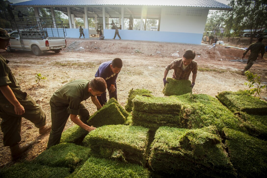 Service members with the Royal Thai Navy, Japanese Ground Self-Defense Force, and U.S. Marines with Marine Wing Support Squadron 171, work together to build a multi-purpose room at the Ban Cham Kho School, in Rayong, Thailand, during exercise Cobra Gold, Feb. 15, 2016. Cobra Gold, in its 35th iteration, includes a specific focus on humanitarian civic action, community engagement, and medical activities conducted during the exercise to support the needs and humanitarian interests of civilian populations around the region. 