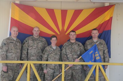 Nashville, Tenn., resident Sgt. Brian Bertram, Glendale, Ariz., resident Sgt. Nicholas Robinson, San Tan Valley, Ariz., resident Cpt. Sherri Gregoire, Tucson, Ariz., resident 1st Sgt. Trevor Varney, and Phoenix resident Sgt. 1st Class Kevin Stockard gather outside their company headquarters for Company F, 1st Battalion, 168th Air Traffic Services, 40th Combat Aviation Brigade, at Camp Buehring Kuwait, Feb. 8. Capt. Gregoire and 1st Sgt. Varney are the command team for Company F, which provides Air Traffic Services for all friendly aviation assets. (Photo by 1st Lt. Aaron DeCapua, 40th Combat Aviation Brigade Public Affairs)