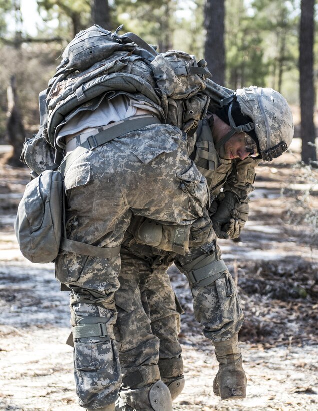 Facing a wind chill below freezing, a Soldier in basic combat training with C Company, 1st Battalion, 61st Infantry Regiment at Fort Jackson, S.C., struggles to evacuate a casualty by using a firemen's carry at Victory Forge, Feb. 10, 2016. During Victory Forge, Soldiers’ mental and physical abilities are tested to the limits. They are evaluated on everything they’ve learned in the prior eight weeks of training; from basic first aid to security and reconnaissance patrols. (U.S. Army photo by Sgt. 1st Class Brian Hamilton)
