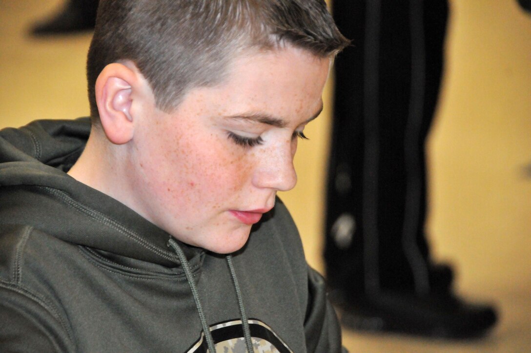 Matt Hann, a 12-year-old at Hammonton Middle School in Hammonton, New Jersey, works on making a candle during Operation Love Letters. Operation Love Letters is an annual patriotic celebration of love which takes place every February. Friends and family of fallen Soldiers gather to pay tribute to them. Survivor Outreach Services at the Army Reserve's 99th Regional Support Command, headquartered at Joint Base McGuire-Dix-Lakehurst, N.J., hosted Operation Love Letters Feb. 13 in the Maj. John P. Pryor Army Reserve Center.