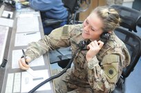 Spc. Madeline Craver, a Lancaster, Pa., resident, and air traffic control operator with Company F, 1st Battalion, 168th Air Traffic Services, 40th Combat Aviation Brigade, relays information to aviators on flight following, at Camp Buehring, Kuwait, Feb. 8. Air Traffic Service operators use to obtain data to relay to the pilots, bringing aviators safely to the ground. (Photo by 1st Lt. Aaron DeCapua, 40th Combat Aviation Brigade Public Affairs)
