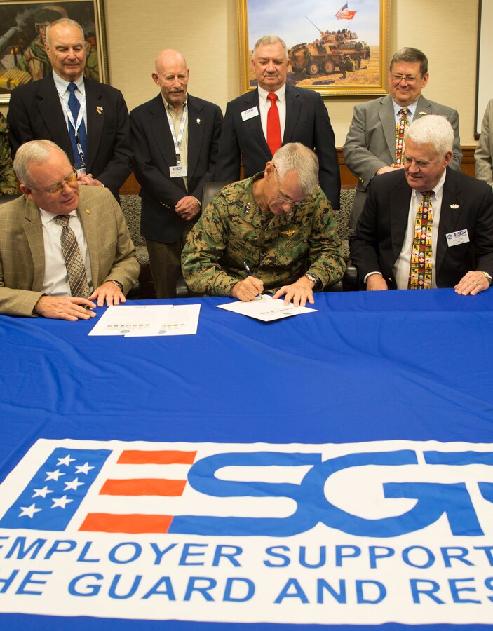 Lt. Gen. Rex C. McMillian (center), commander of Marine Forces Reserve, signs the Statement of Support for the Guard and Reserve, Feb. 12, 2016, at Marine Corps Support Facility New Orleans. The Statement of Support is a document for employers to sign to show their support in assisting Guard and Reserve members finds new or better jobs. (U.S. Marine Corps photo by Lance Cpl. Melissa Martens)