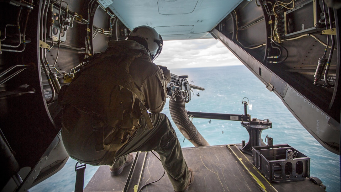 Lance Cpl. Jarod L. Smith, a crew chief with Marine Medium Tiltrotor Squadron 365, fires a mounted M2 Browning .50-caliber machine gun from the back of the MV-22B Osprey during a live fire training session off the coast of Marine Corps Air Station New River, N.C., Feb. 10, 2016. Marines with VMM-365 flew to a landing zone, which allowed pilots to practice CALs in their Osprey’s and then flew several miles off the coast to practice their proficiency with the .50-caliber  machine gun. 