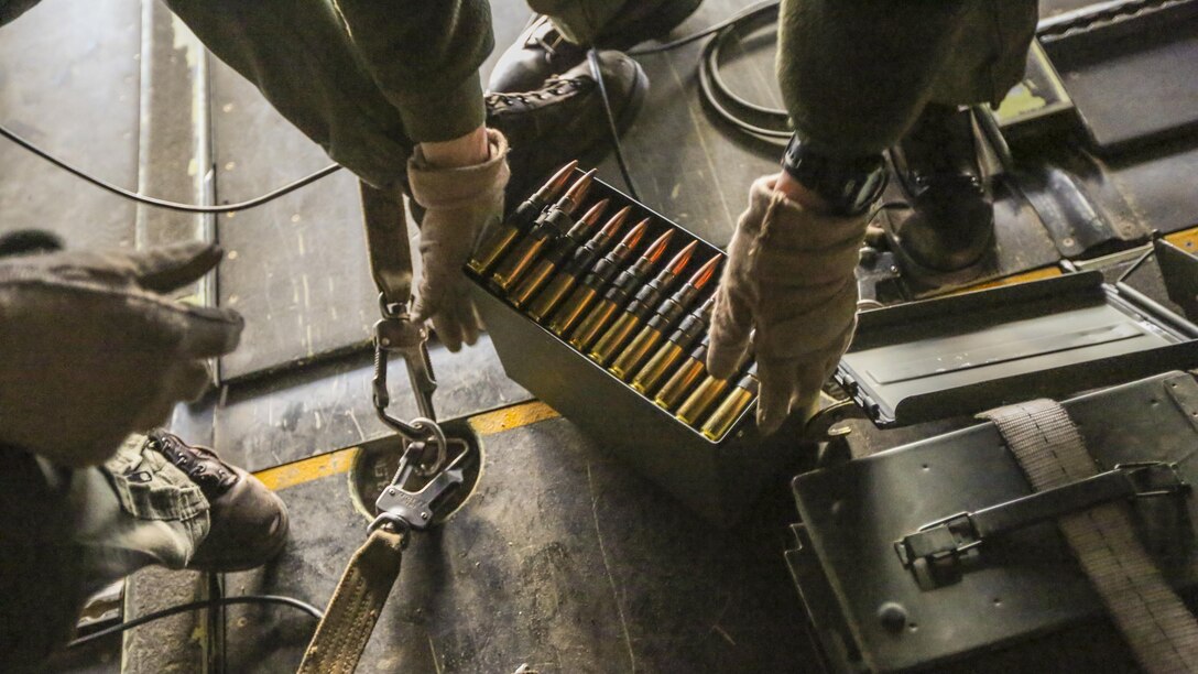 Staff Sgt. Anthony C. Knight, a crew chief with Marine Medium Tiltrotor Squadron 365, prepares a box of belt fed .50-caliber rounds for a gunner during a live fire training session off the coast of Marine Corps Air Station New River, N.C., Feb. 10, 2016. Marines with VMM-365 flew to a landing zone, which allowed pilots to practice CALs in their MV-22B Osprey’s and then flew several miles off the coast to practice shooting the M2 Browning .50-caliber machine gun from the back of the aircraft. 